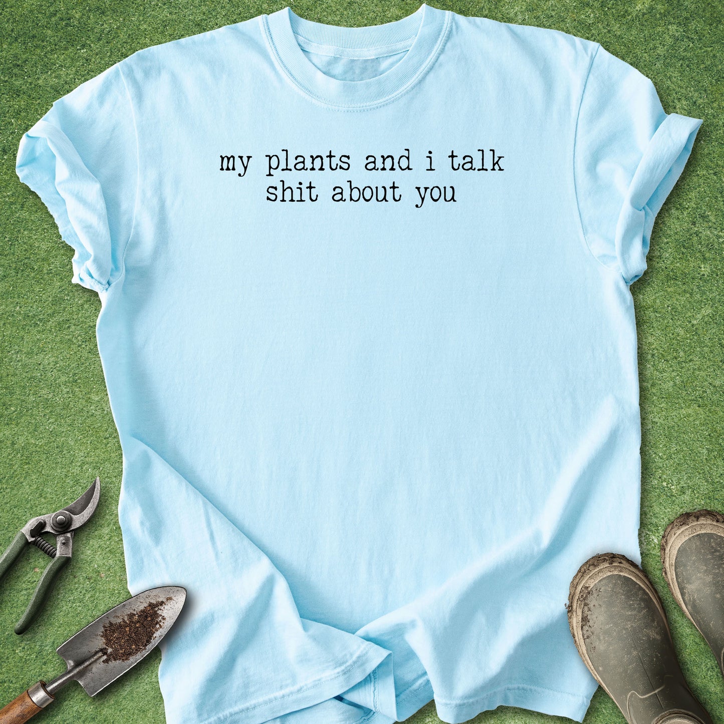 Comfort Colors Blue t-shirt featuring the funny quote "My Plants and I Talk Shit About You" in white vintage-style typewriter lettering.