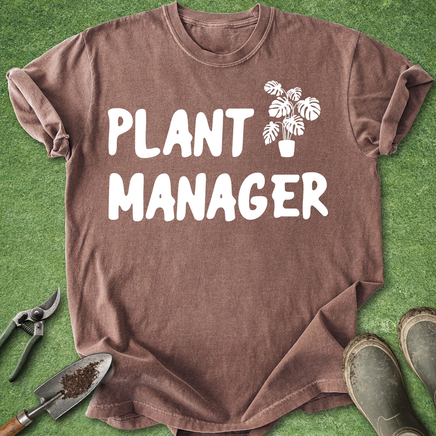 Brown t-shirt with 'Plant Manager' text and plant graphic on green grass background