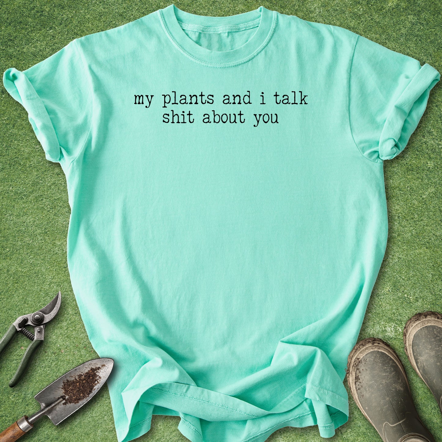 Comfort Colors island-reef t-shirt featuring the funny quote "My Plants and I Talk Shit About You" in white vintage-style typewriter lettering.