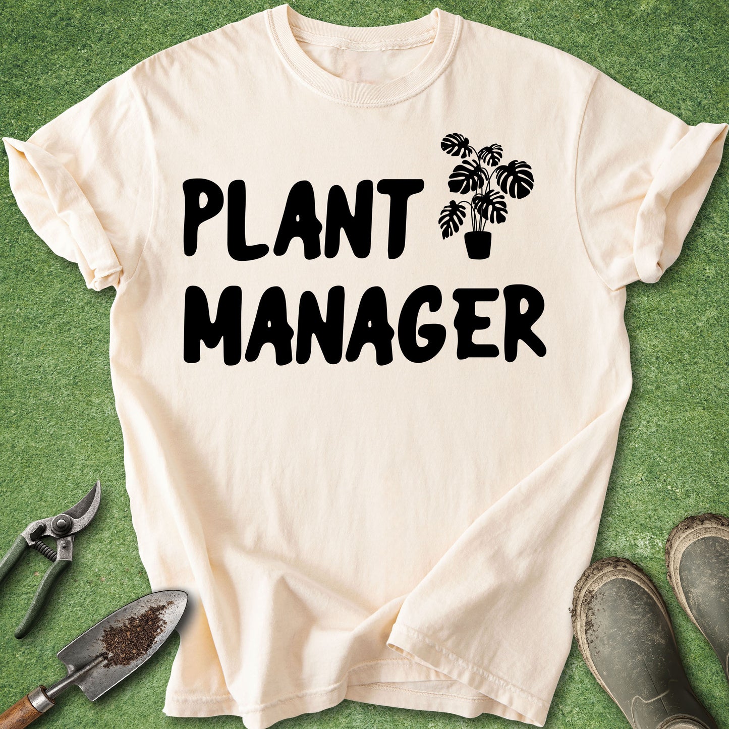 Beige t-shirt with 'Plant Manager' text and plant graphic on a green background