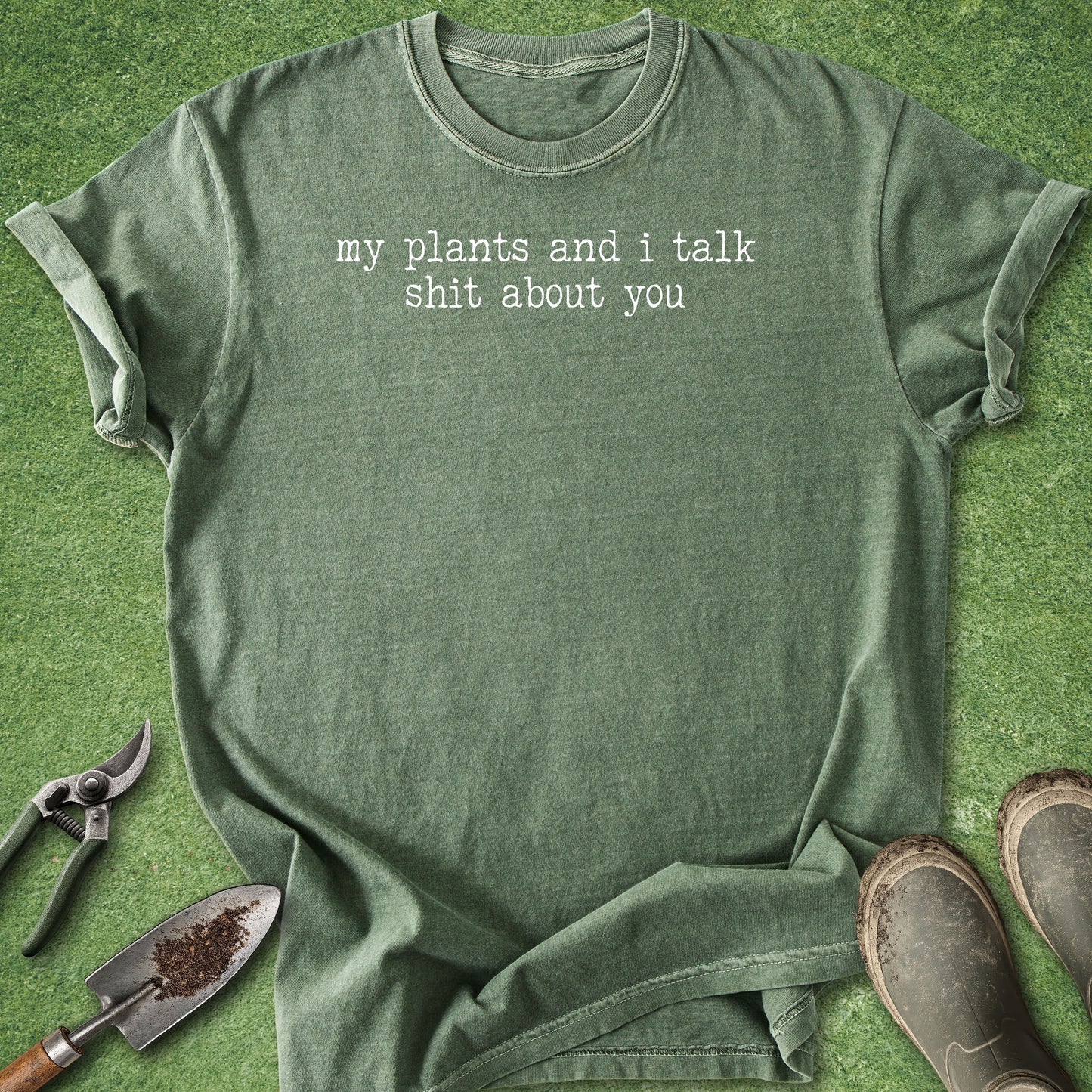 Comfort Colors moss t-shirt featuring the funny quote "My Plants and I Talk Shit About You" in white vintage-style typewriter lettering.