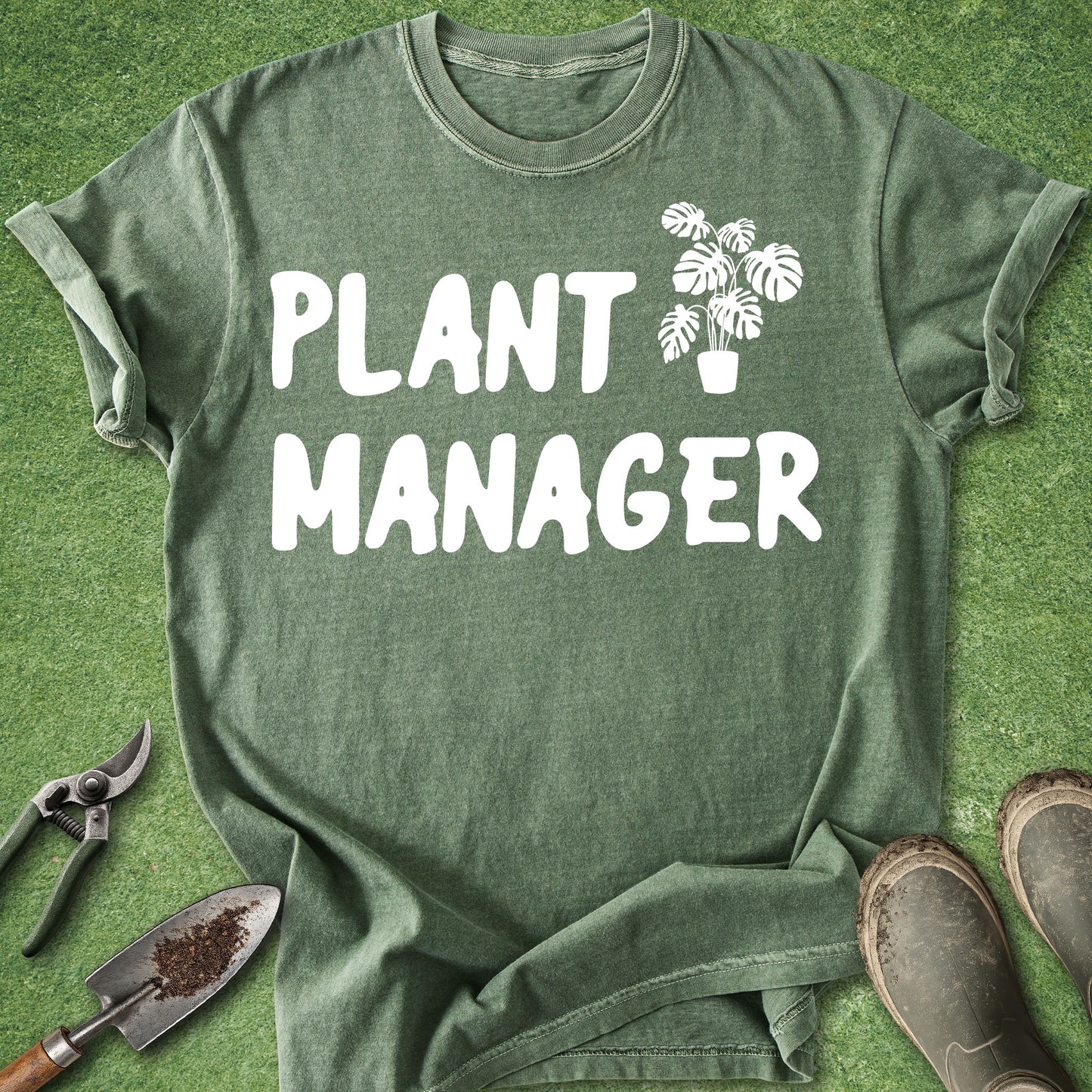 Green t-shirt with 'Plant Manager' text and plant graphic on a grass background