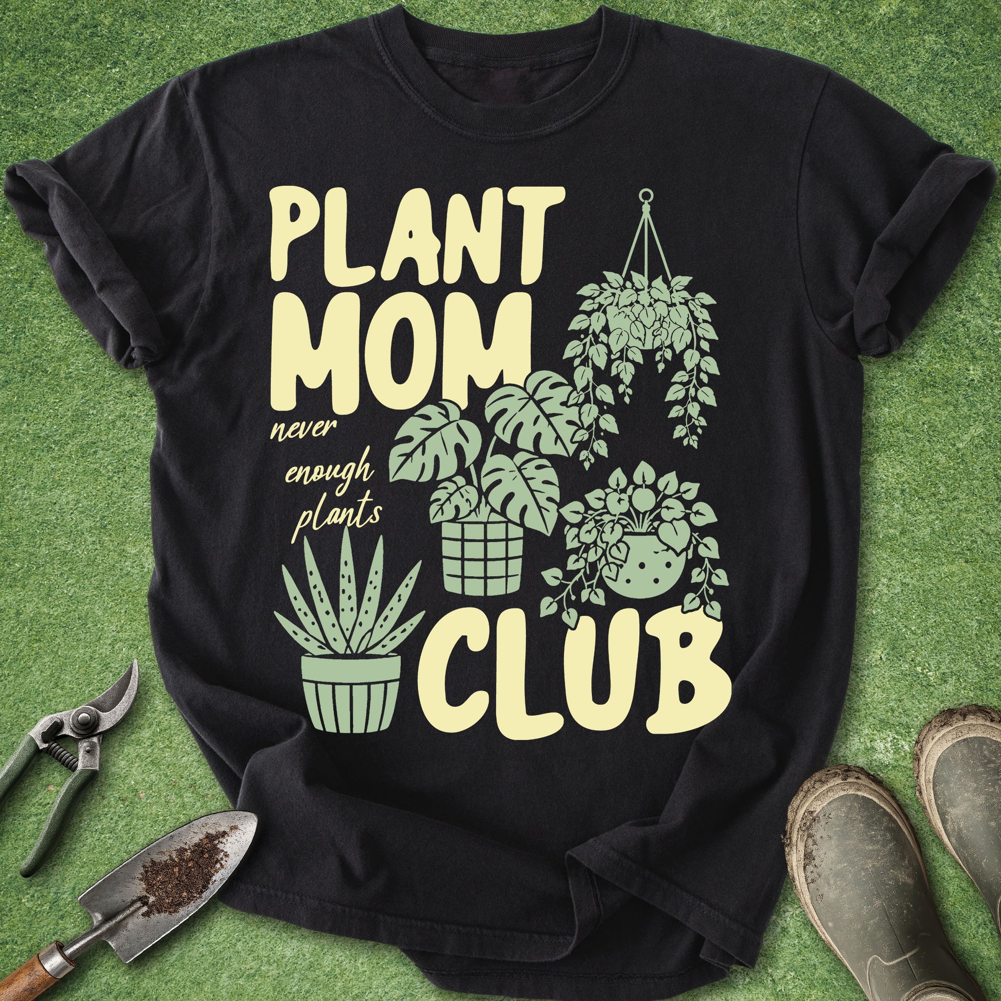 Black t-shirt with 'Plant Mom Club' design on a green grass background
