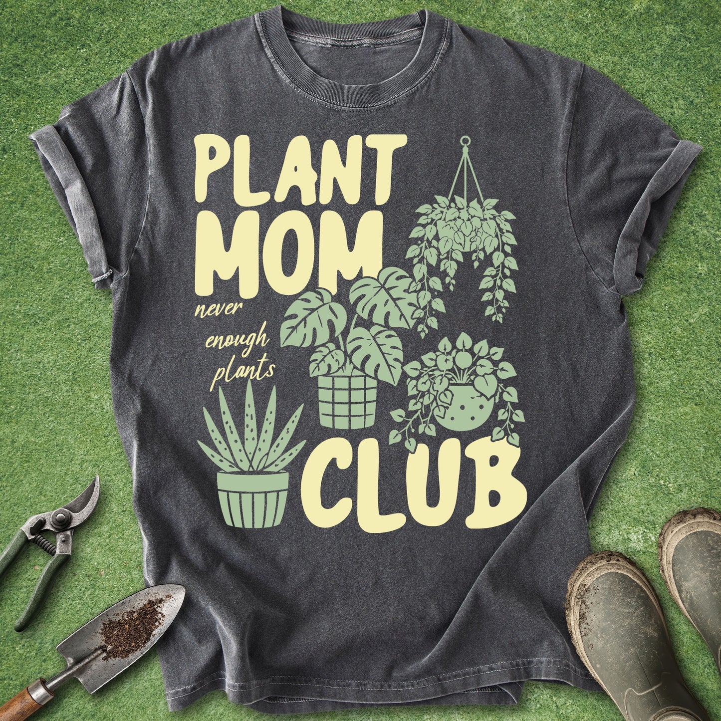Gray t-shirt with 'Plant Mom Club' design on a green grass background