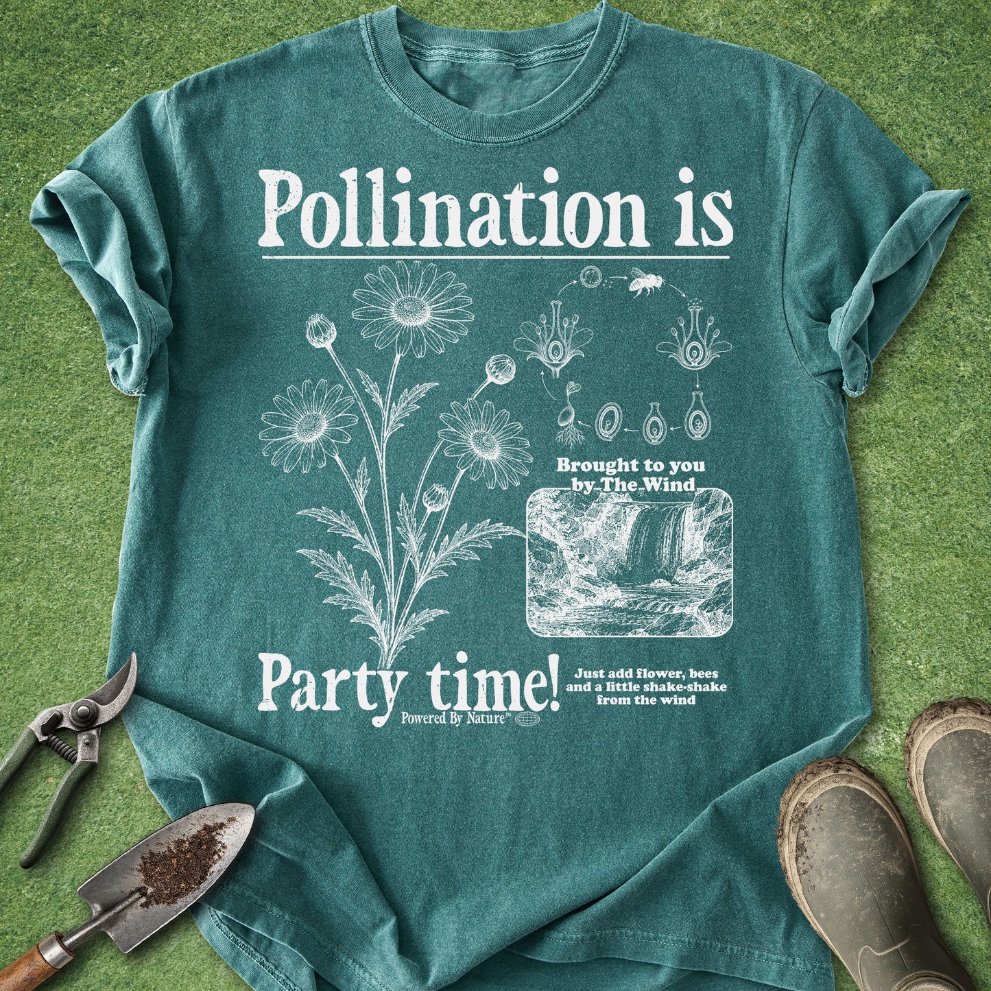 Teal t-shirt with white graphic and text on a grass background