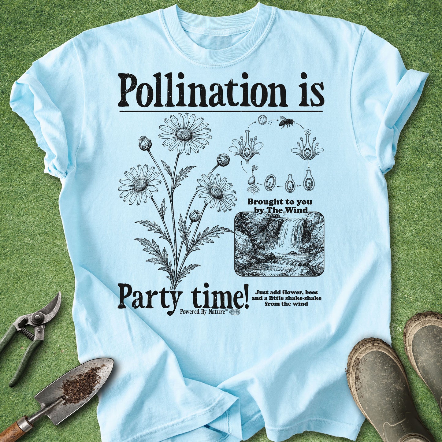 Light blue t-shirt with botanical design and text on a grass background