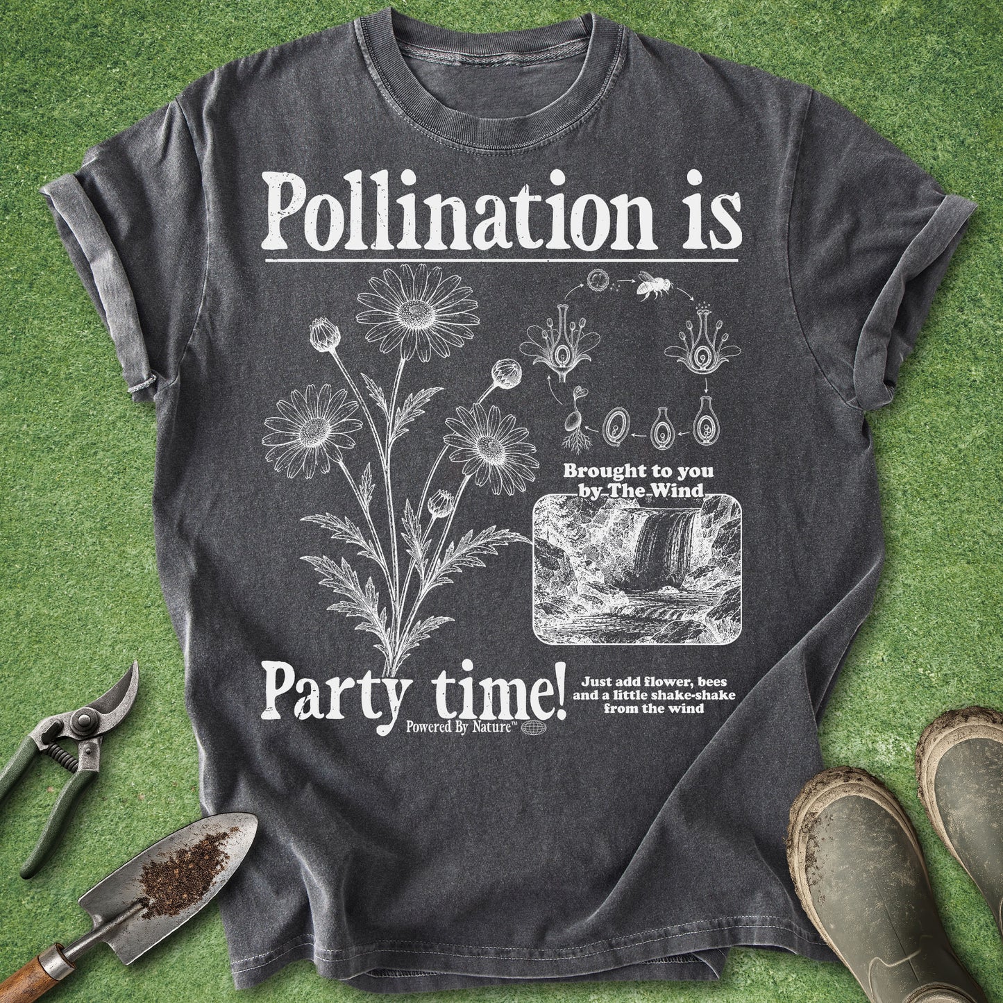 Dark gray t-shirt with floral design and text on a grass background