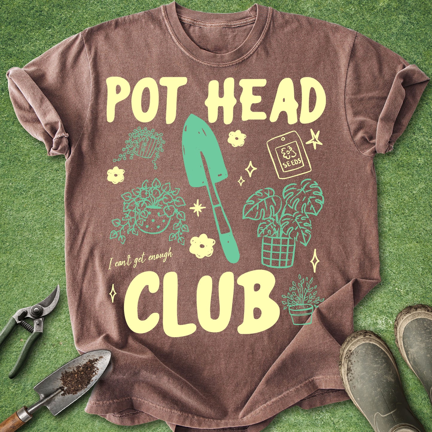 Brown t-shirt with 'POT HEAD CLUB' text and gardening graphics on a green background