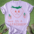 Light purple t-shirt with a strawberry graphic and text on a green background