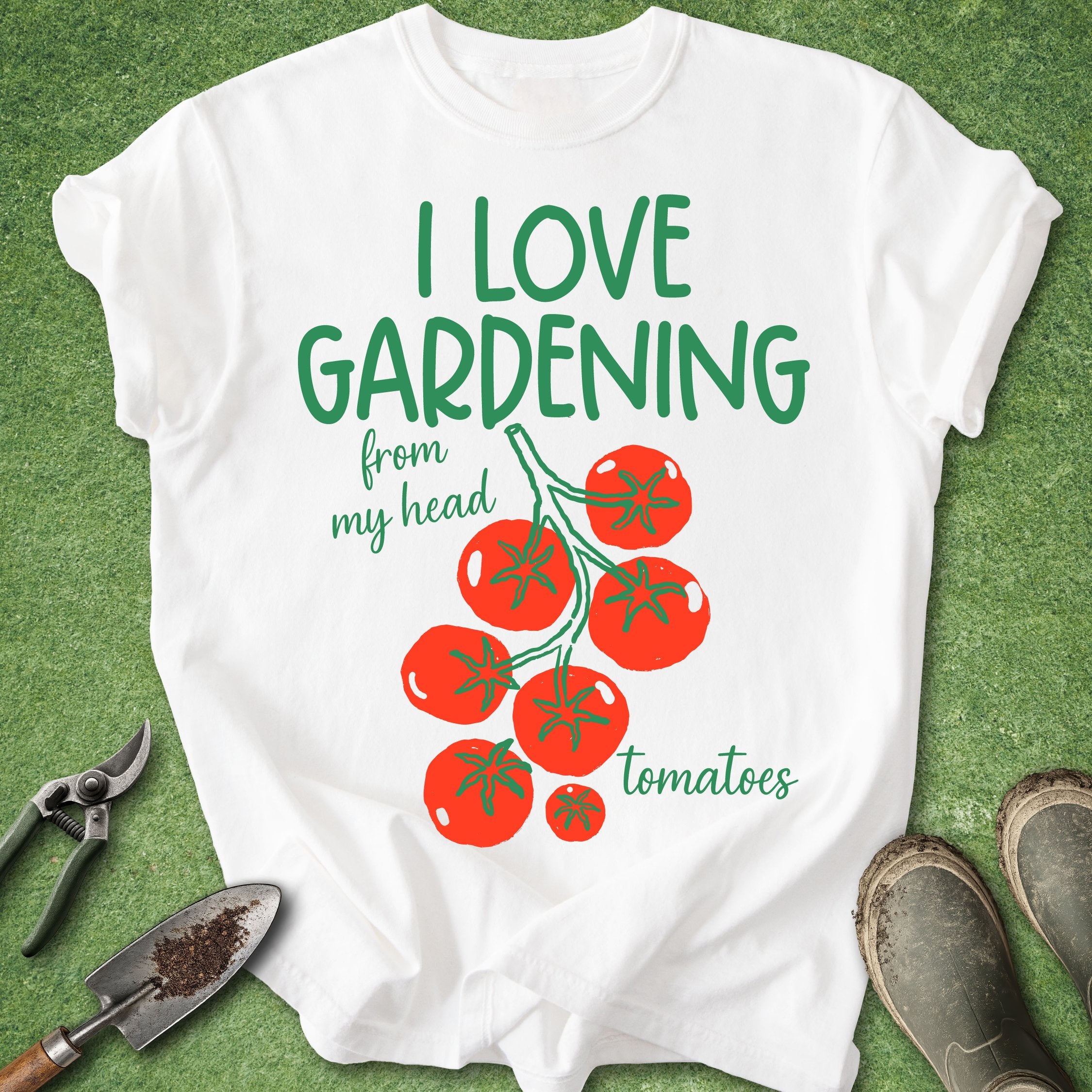 White t-shirt with 'I love gardening from my head tomatoes' text and tomato graphics on a green background.
