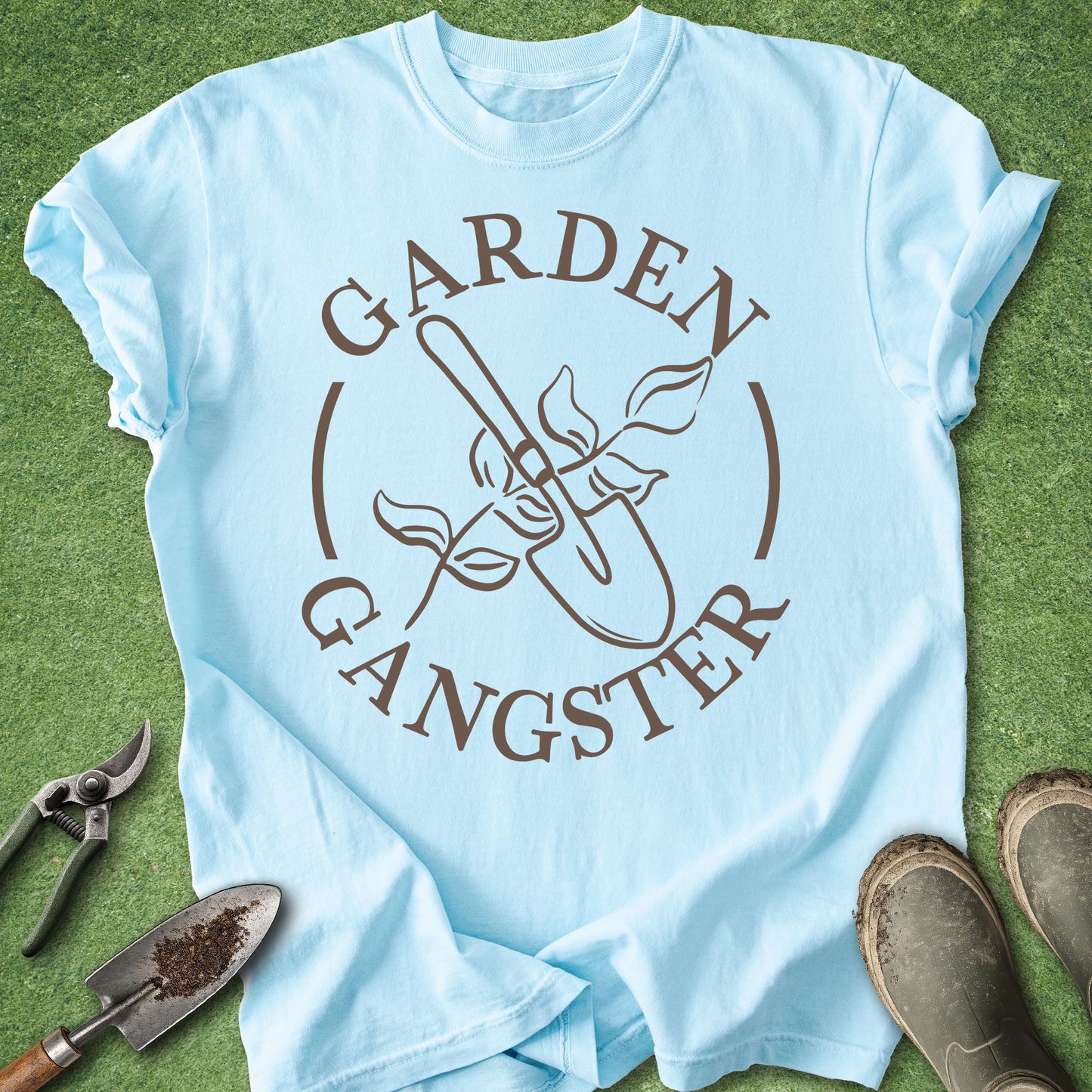 Light blue t-shirt with 'Garden Gangster' design on a grass background