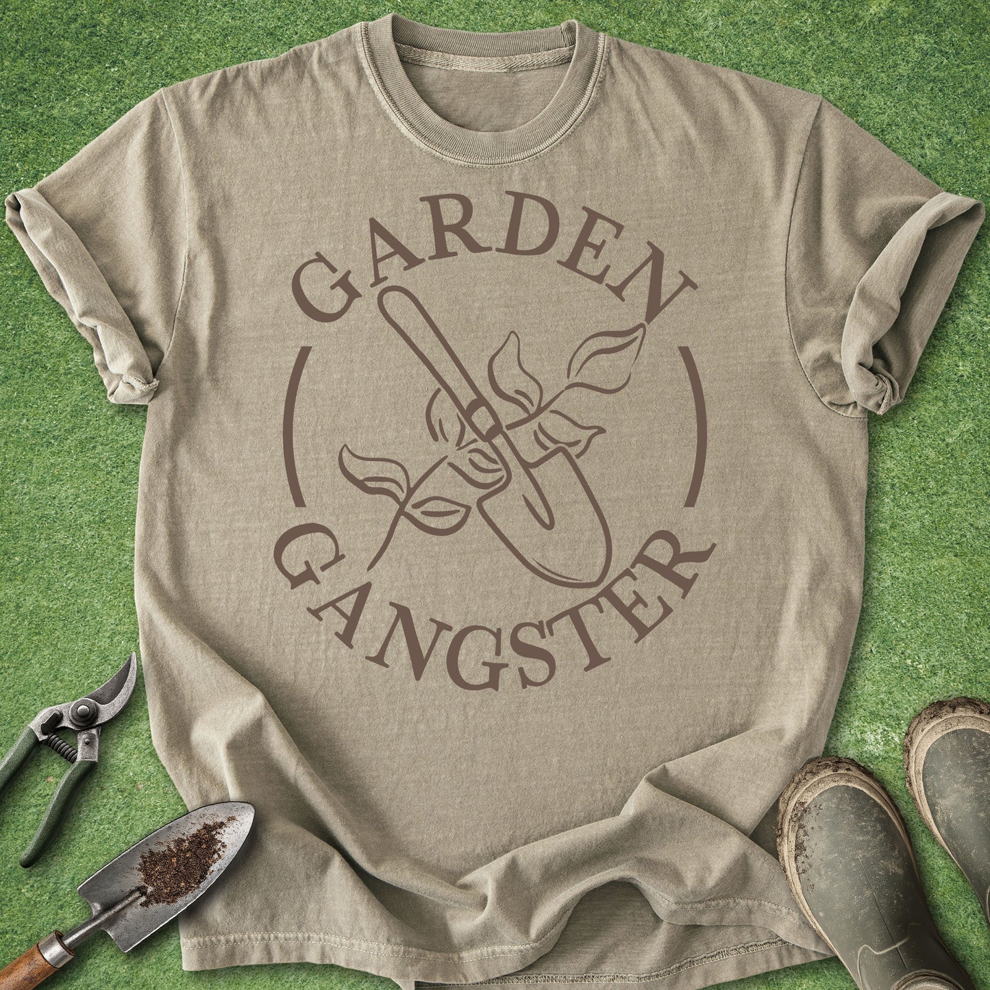 Beige t-shirt with 'Garden Gangster' graphic on a green grass background