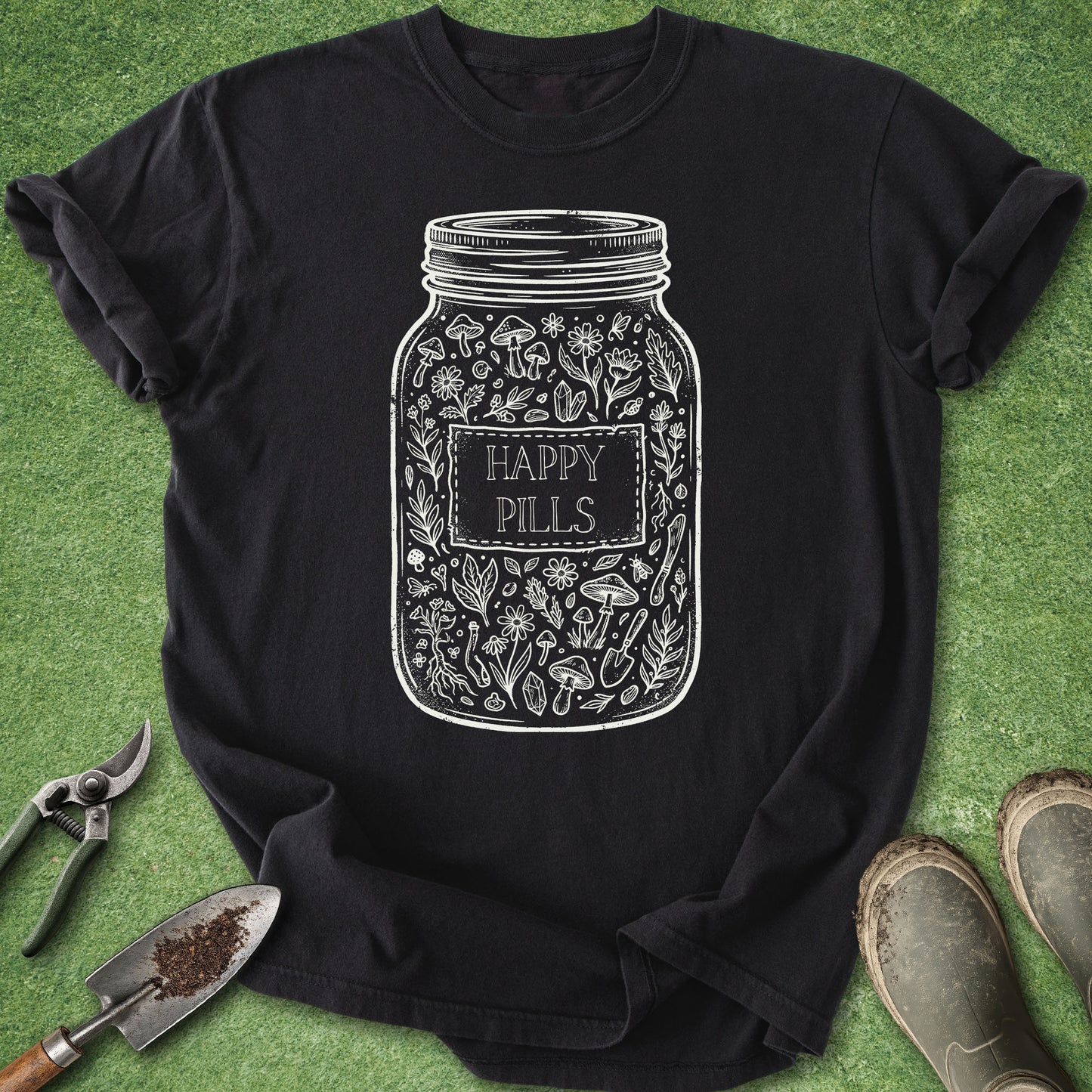 Black t-shirt with 'Happy Pills' jar design on a green grass background