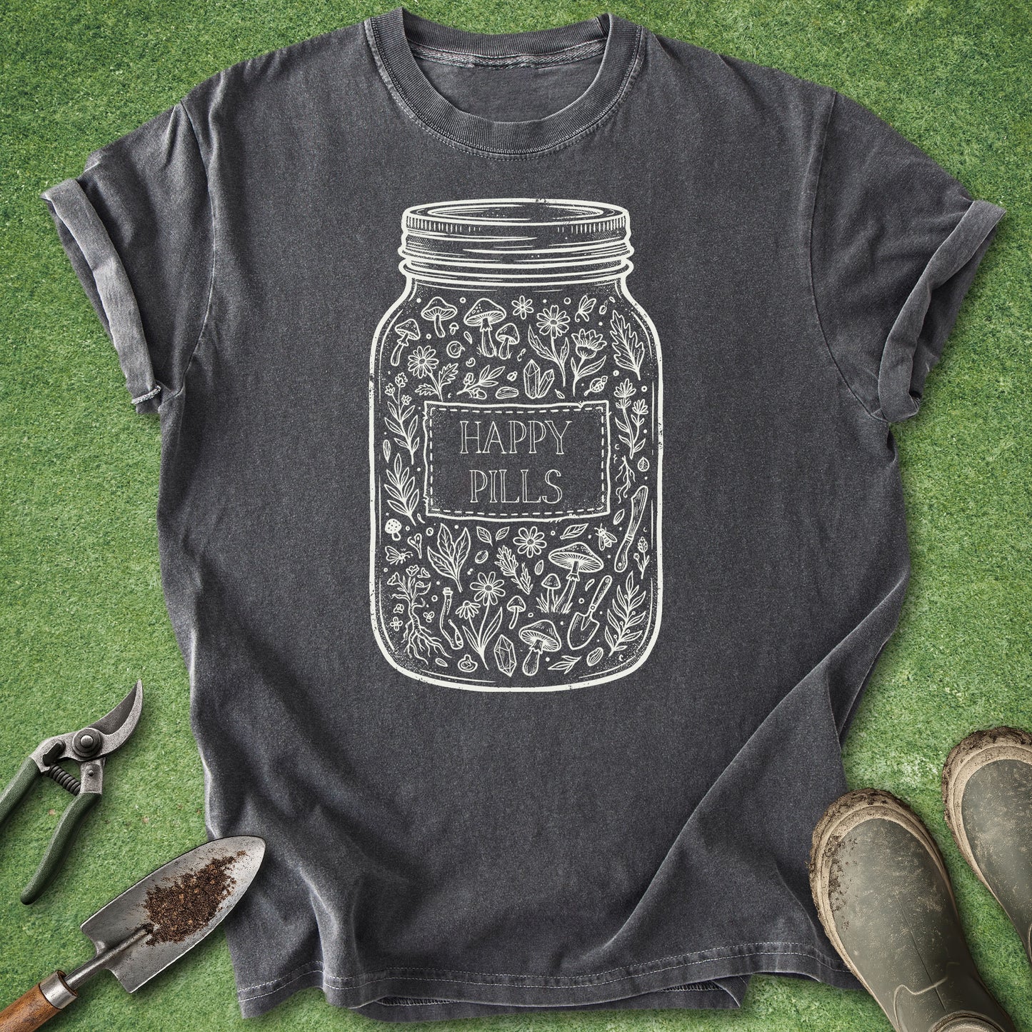 Dark gray t-shirt with 'Happy Pills' jar design on a green grass background