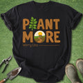 Black t-shirt with 'Plant More Worry Less' text on a green background with gardening tools.