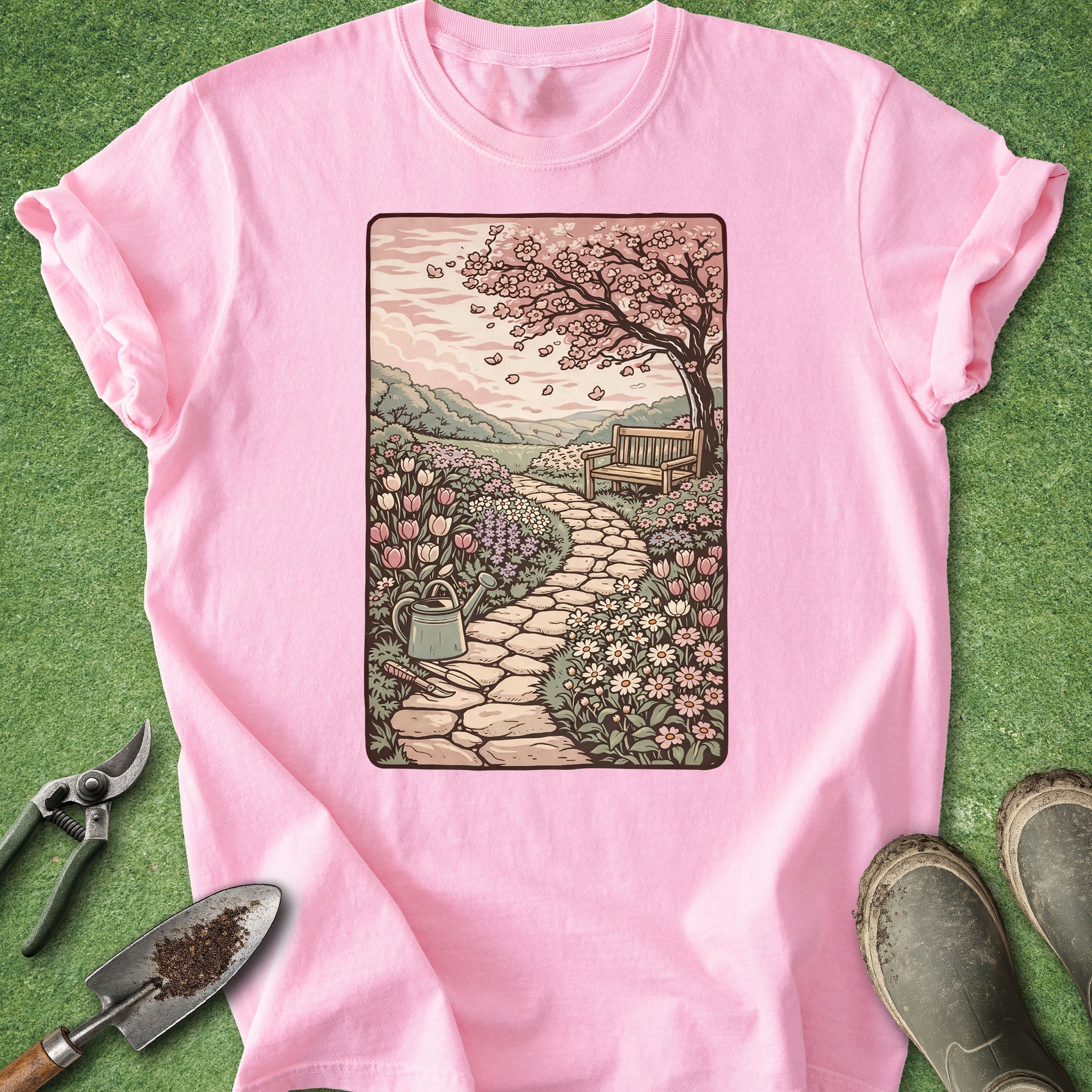 Pink t-shirt with a garden graphic on a green background