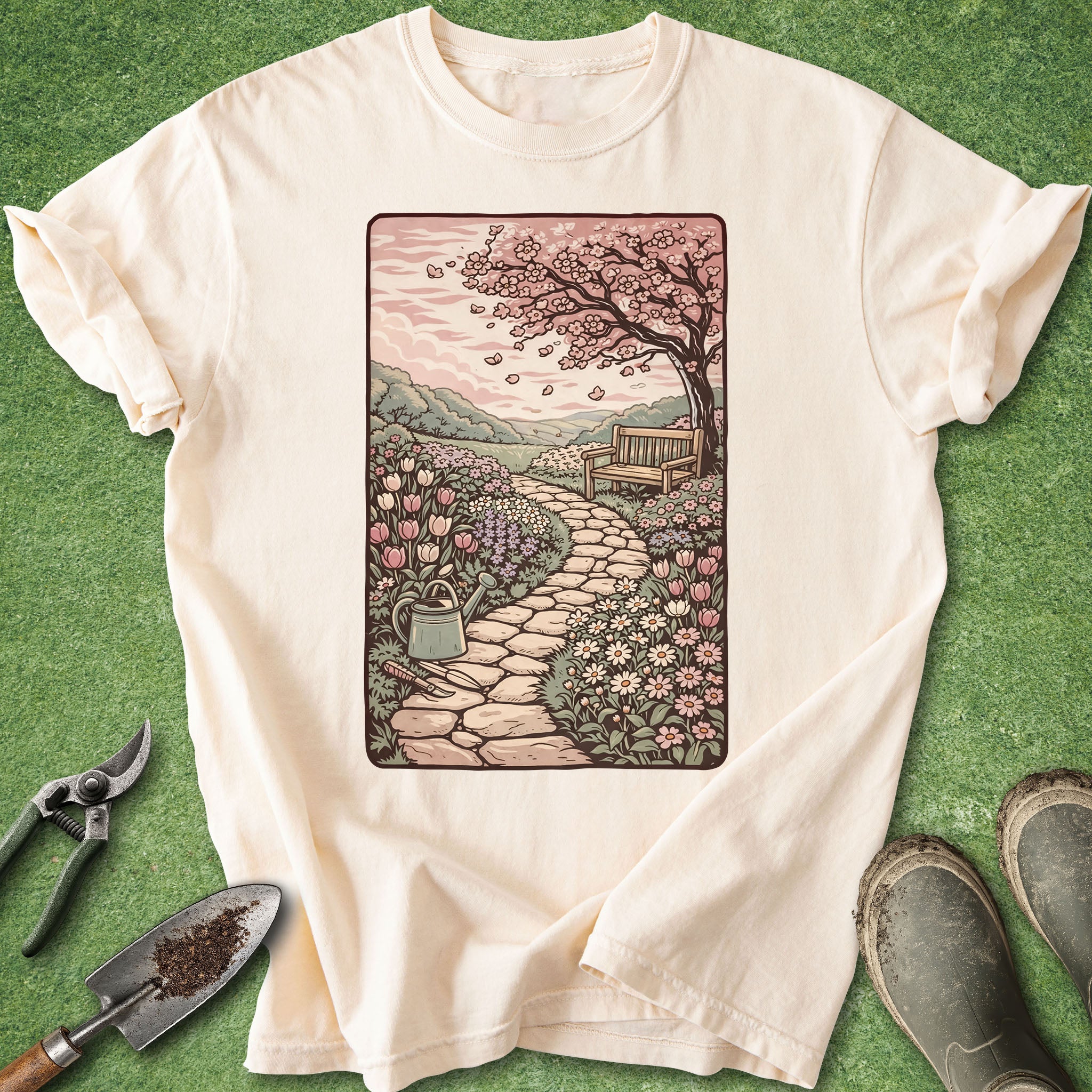 Beige t-shirt with a garden illustration on a green background