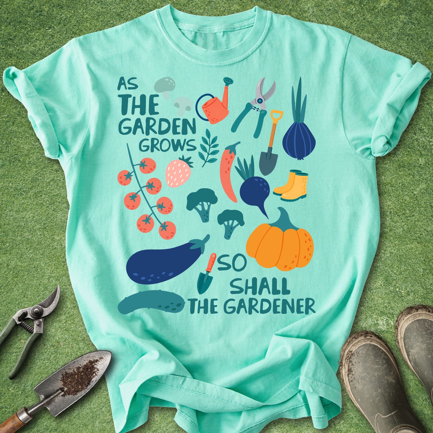 Light blue t-shirt with gardening-themed design on a green background
