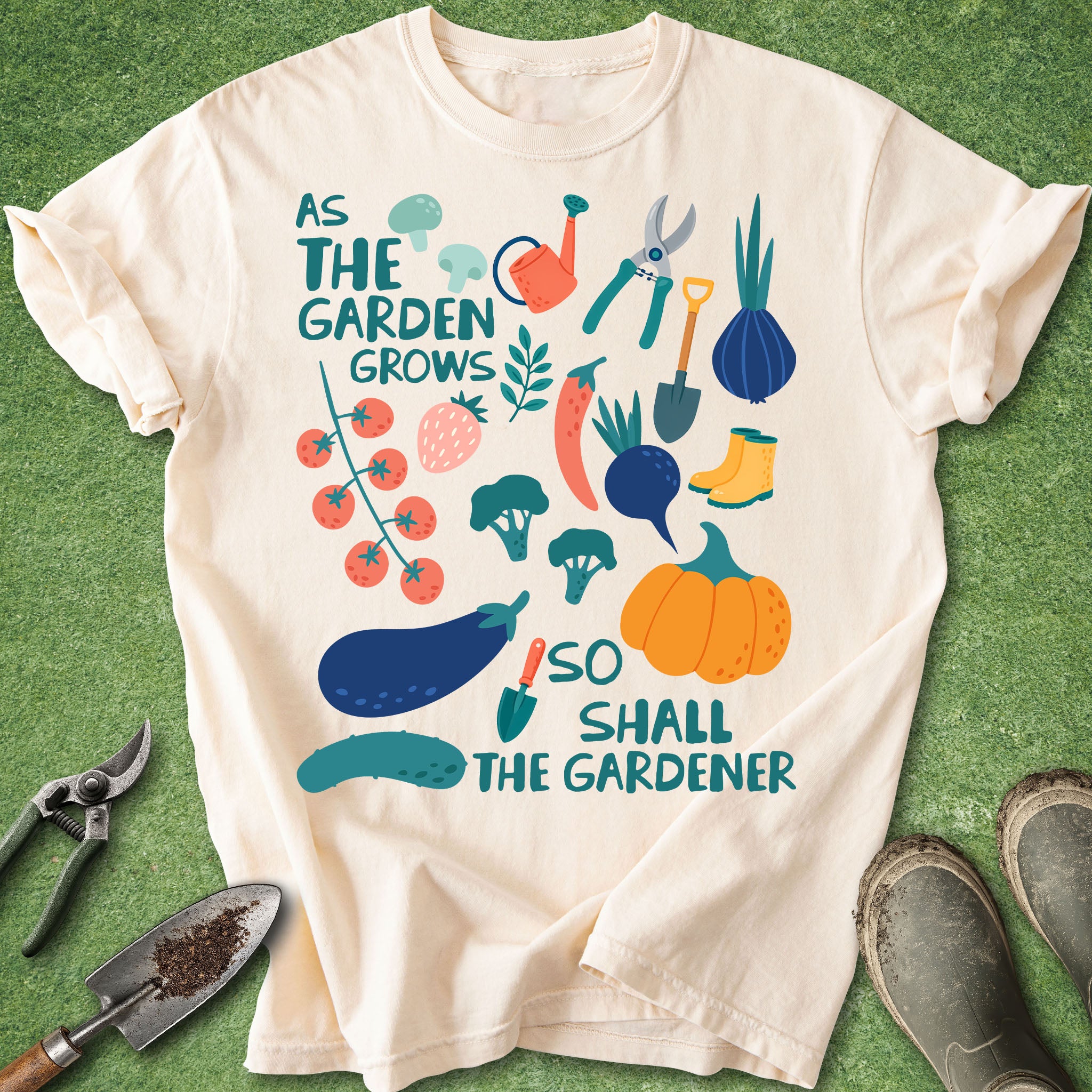 Beige t-shirt with garden-themed design and text on a green background