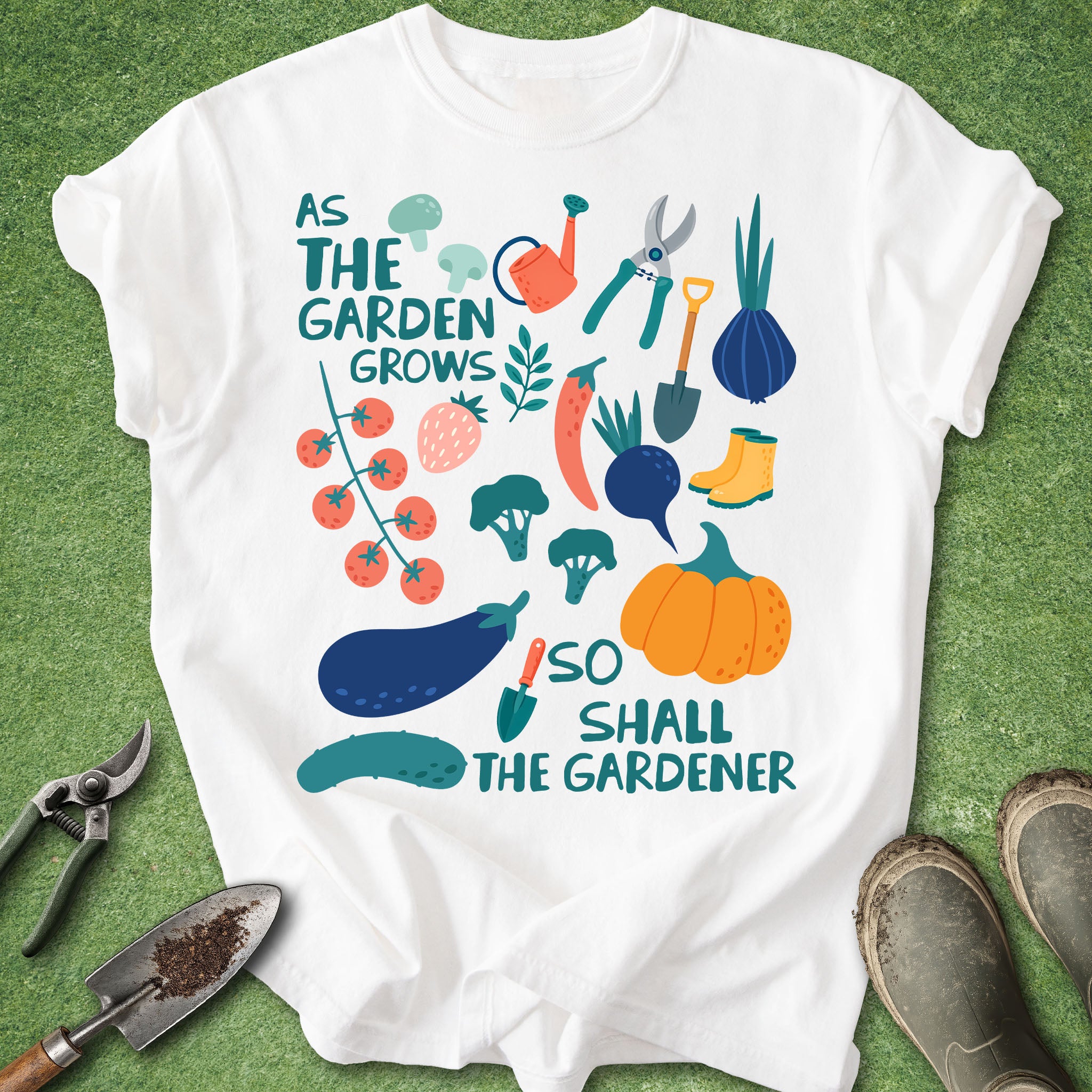 White t-shirt with gardening-themed design and tools on a green background