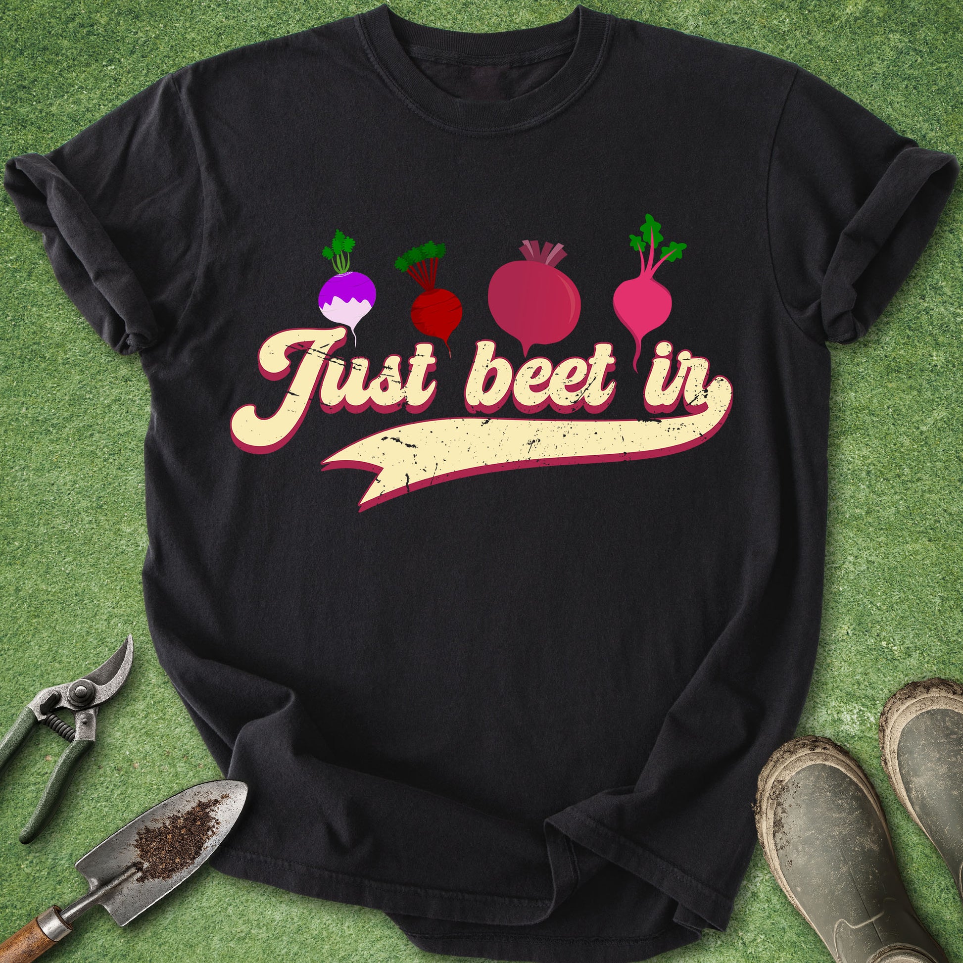 Black t-shirt with 'Just beet in' text and beet graphics on a green background with gardening tools.