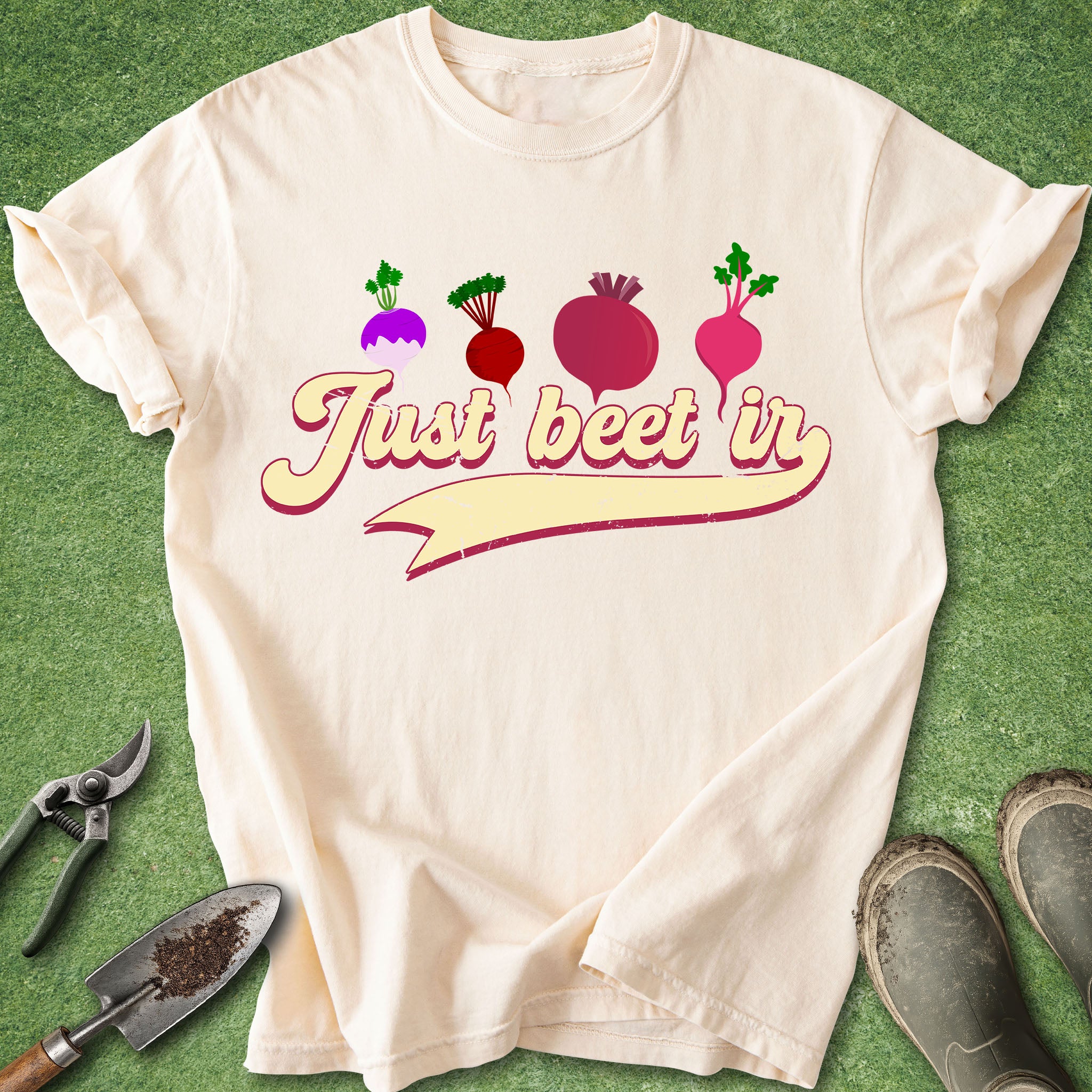 Beige t-shirt with 'Just beet in' text and beet graphics on a green background