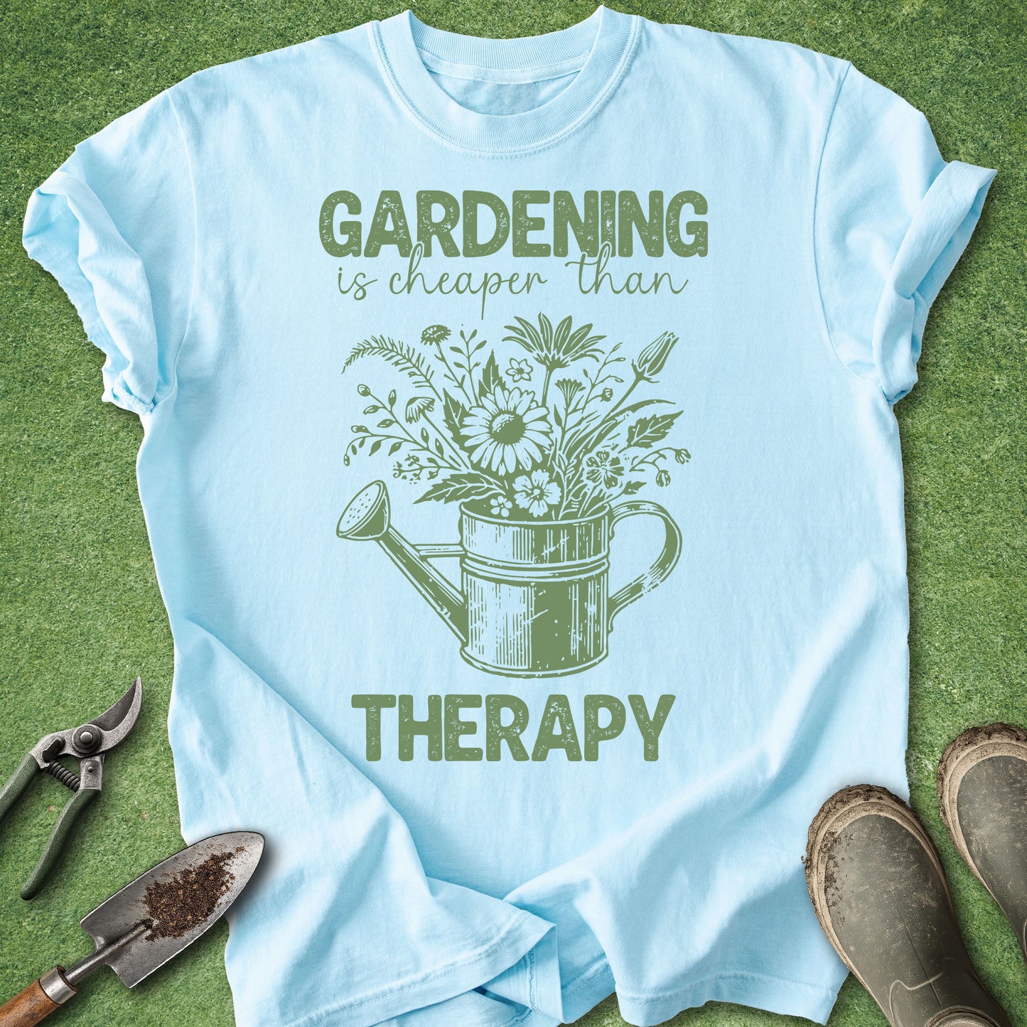 Light blue t-shirt with gardening graphic and text on a grass background
