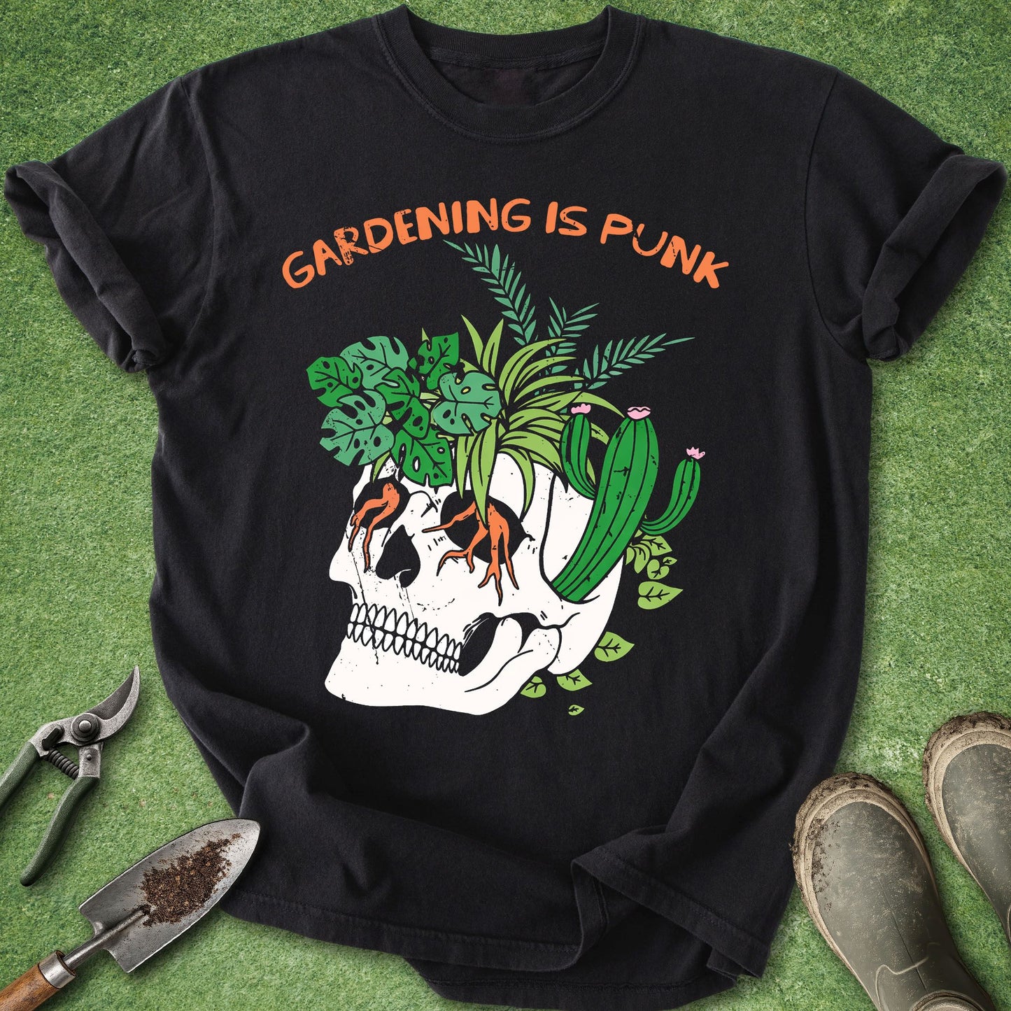 Black t-shirt with skull and plants design on a green background