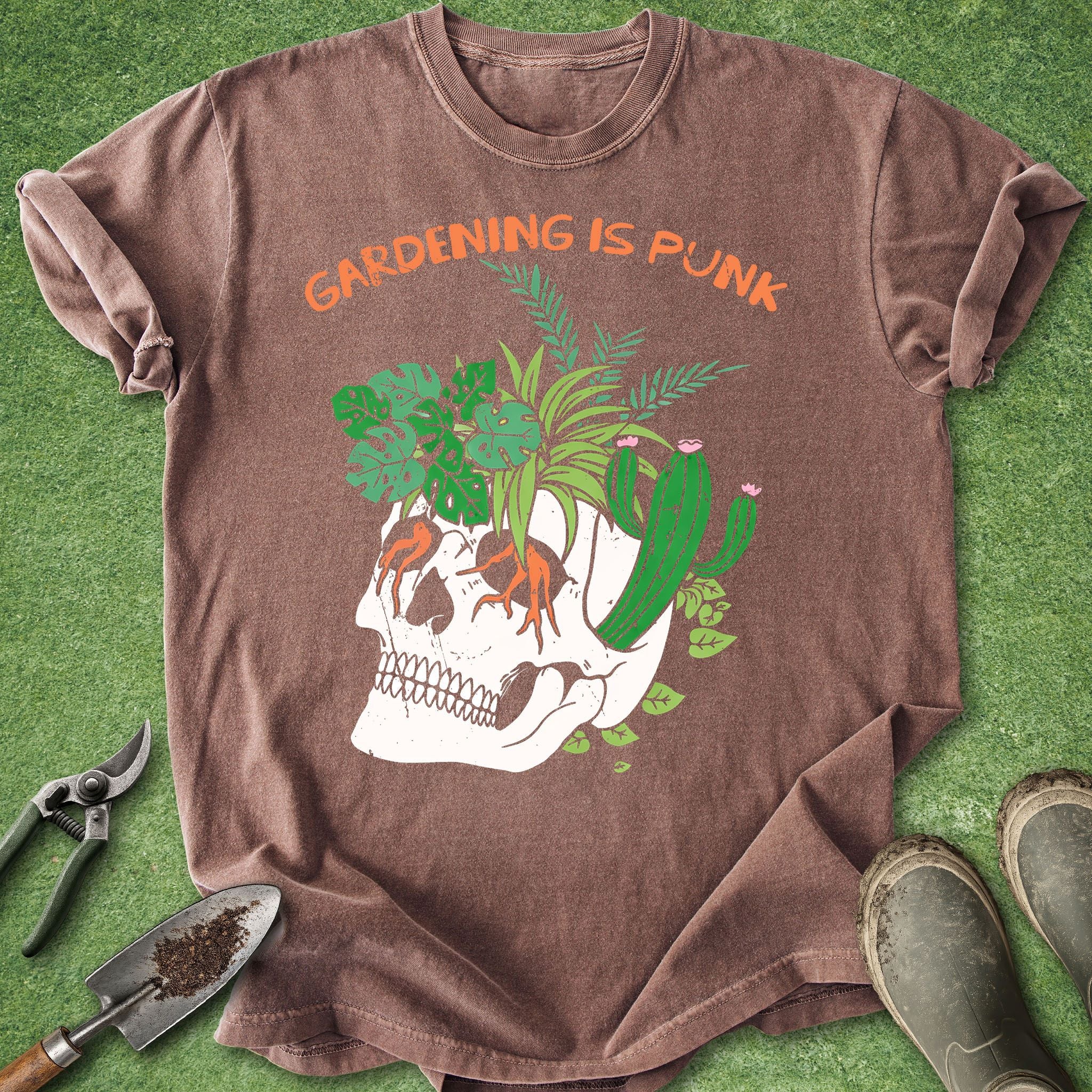 Brown t-shirt with skull and plants design on a green background