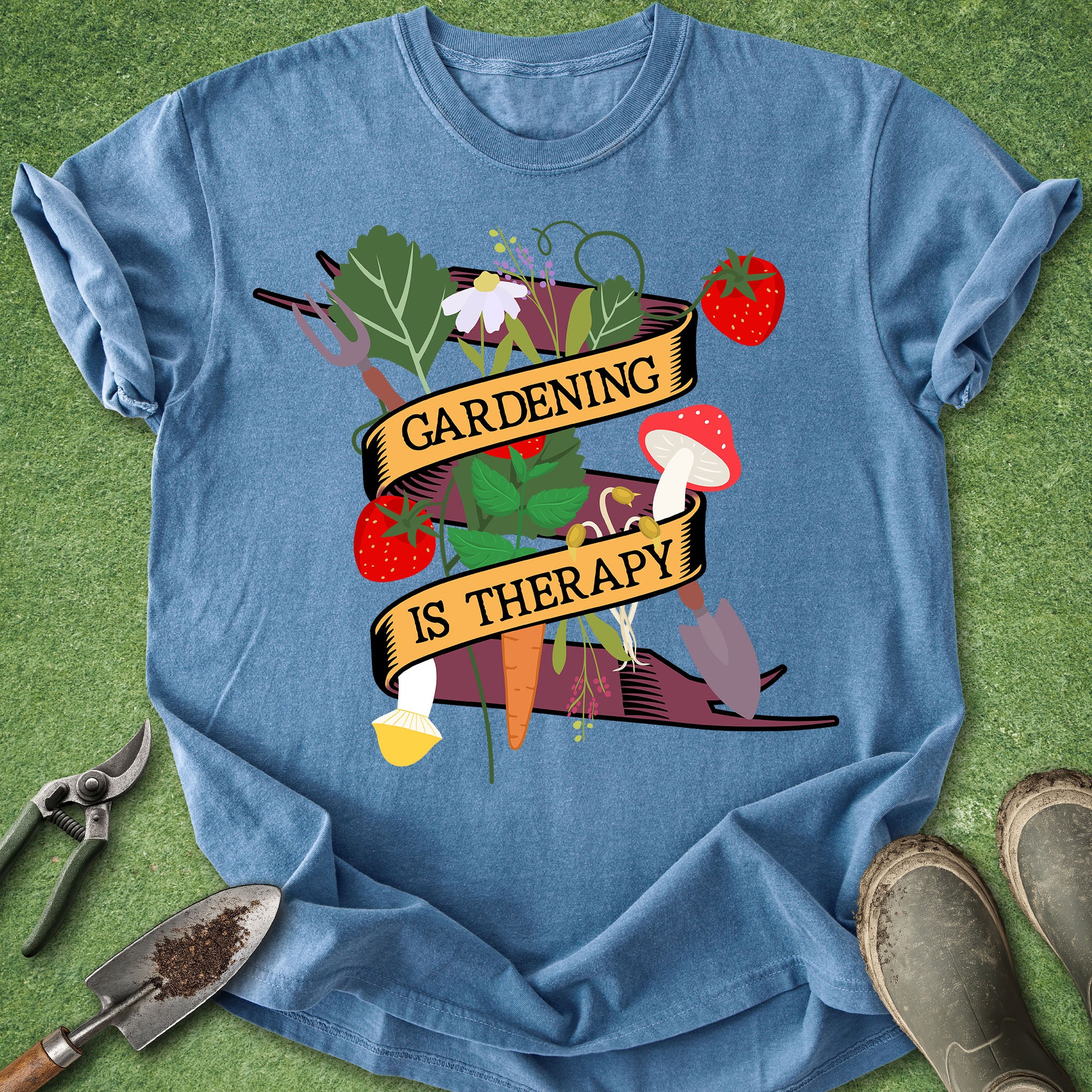 Blue t-shirt with 'Gardening is Therapy' graphic on a grass background