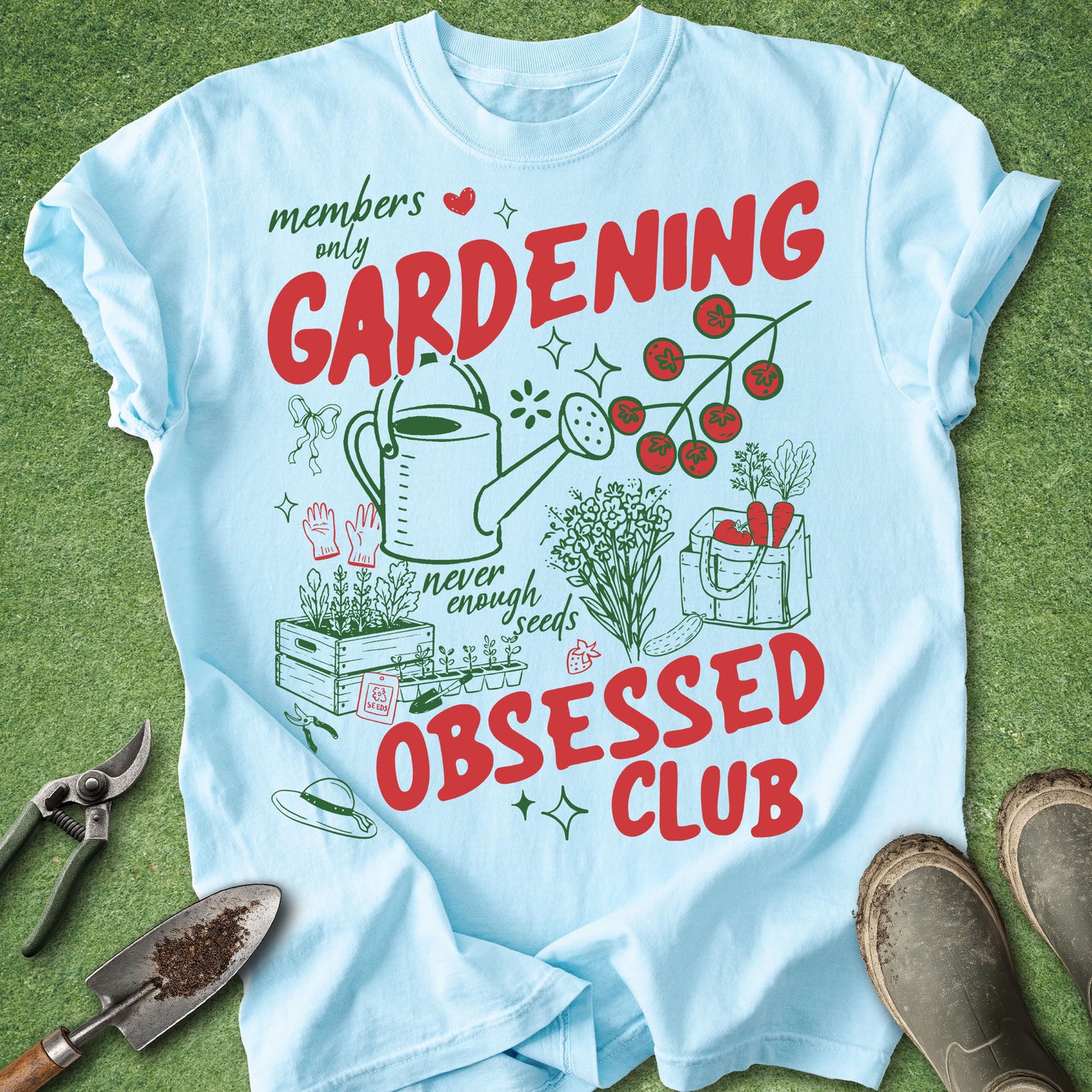 Light blue t-shirt with gardening-themed design on a grass background