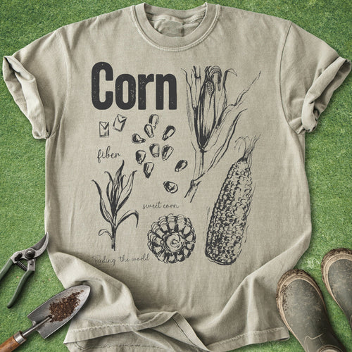 Beige t-shirt with corn illustration and text on a green background