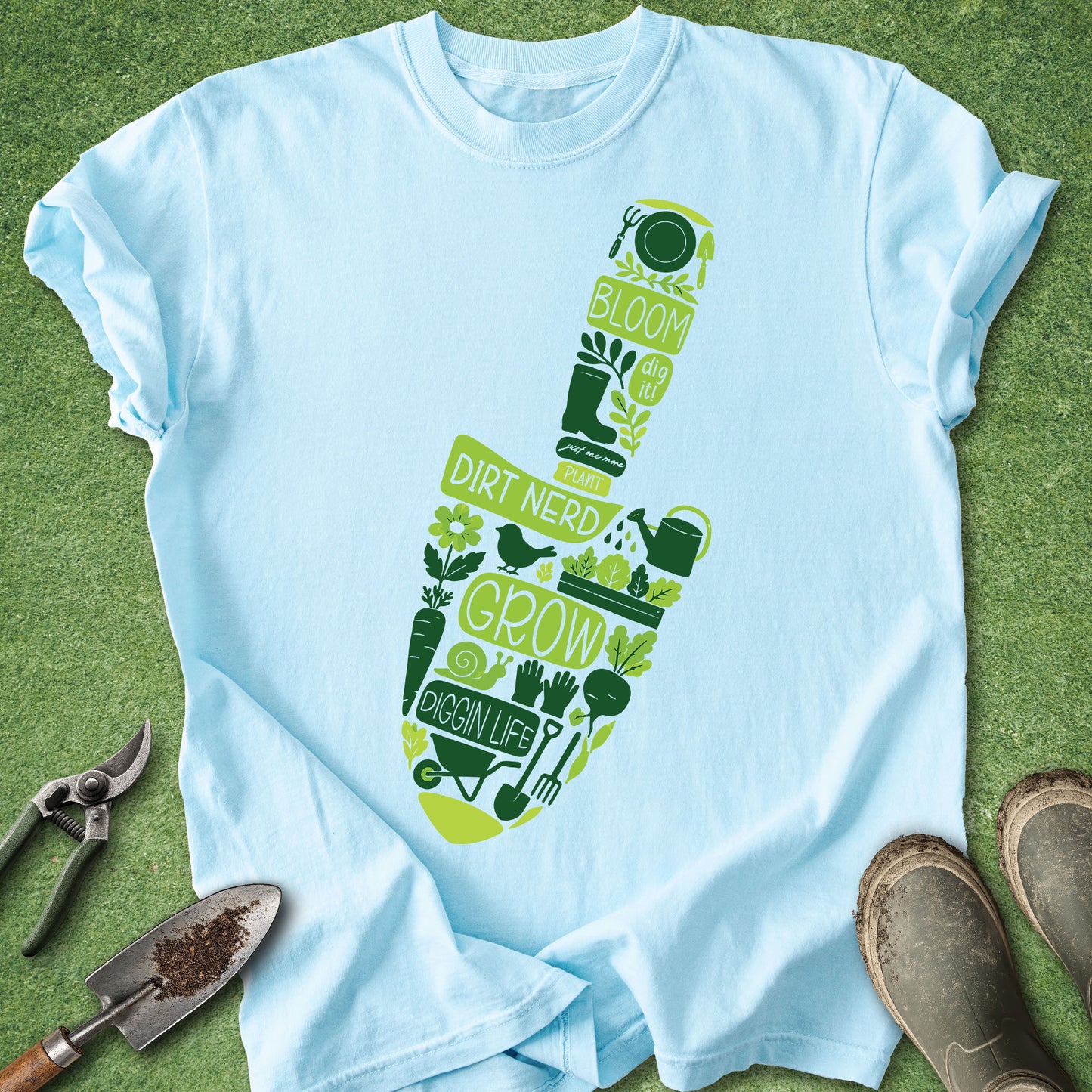 Light blue t-shirt with green gardening-themed design on a grass background