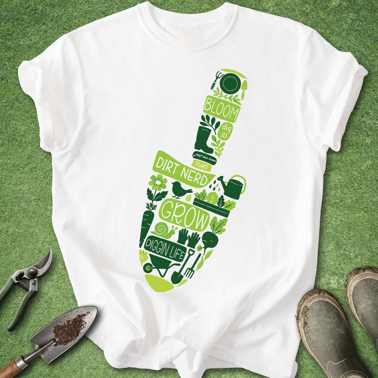 White t-shirt with green gardening-themed design on a green background with gardening tools.