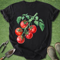 Black t-shirt with red tomato graphic on a green grass background