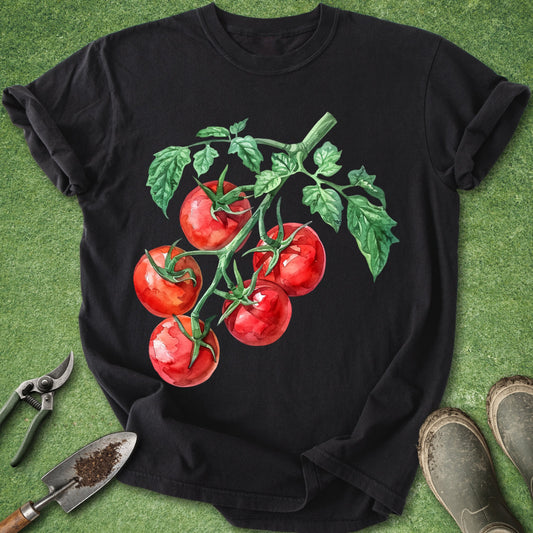 Black t-shirt with red tomato graphic on a green grass background