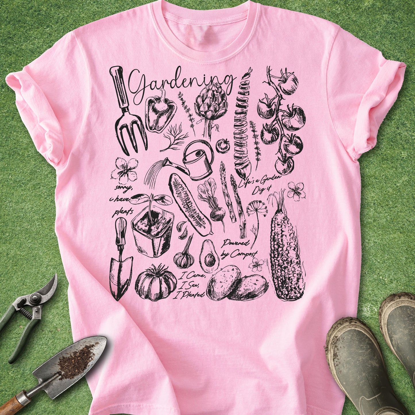 Pink t-shirt with black gardening illustrations on a green background