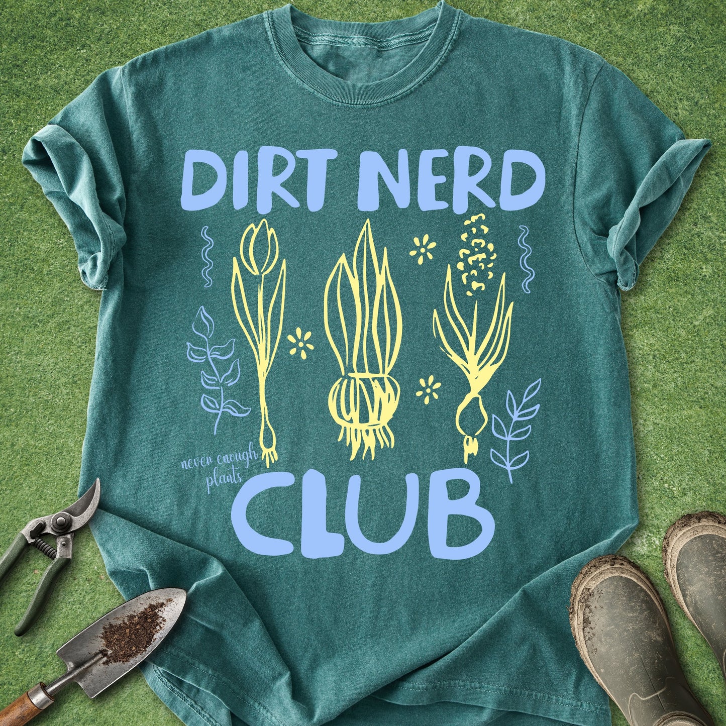 Green t-shirt with 'Dirt Nerd Club' design on a grass background