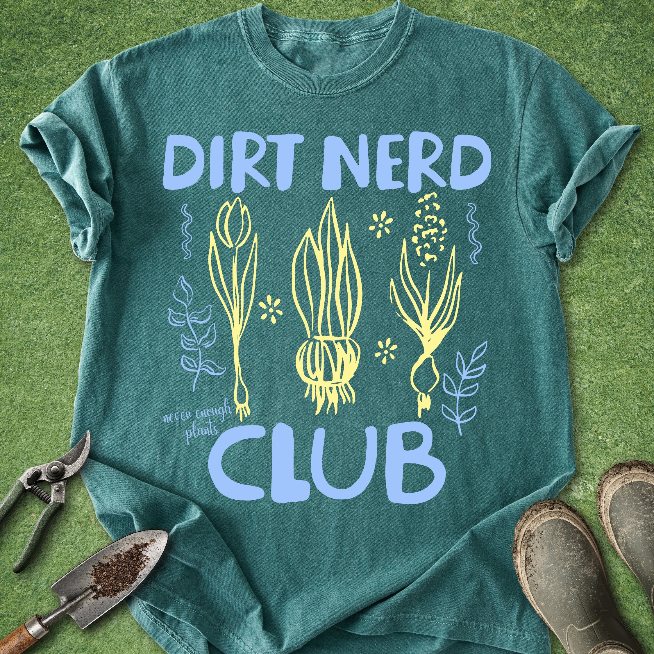 Green t-shirt with 'Dirt Nerd Club' design on a grass background