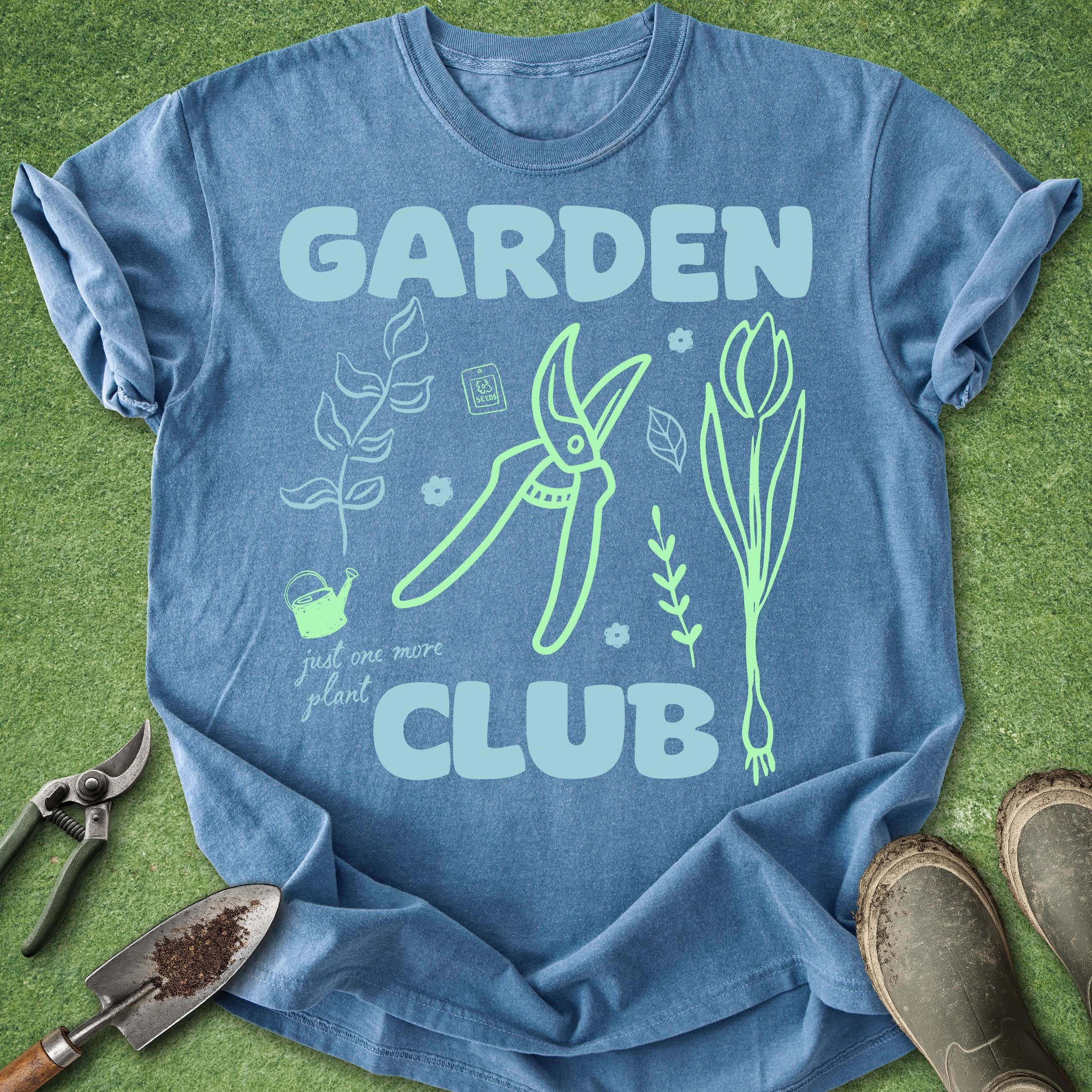 Blue t-shirt with 'Garden Club' design on a grass background