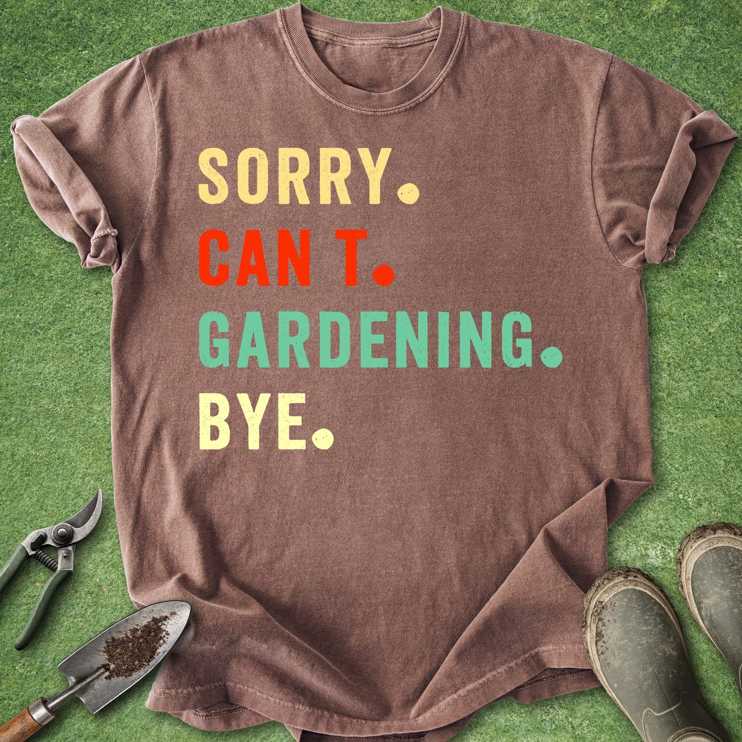 Brown t-shirt with colorful text on a green grass background