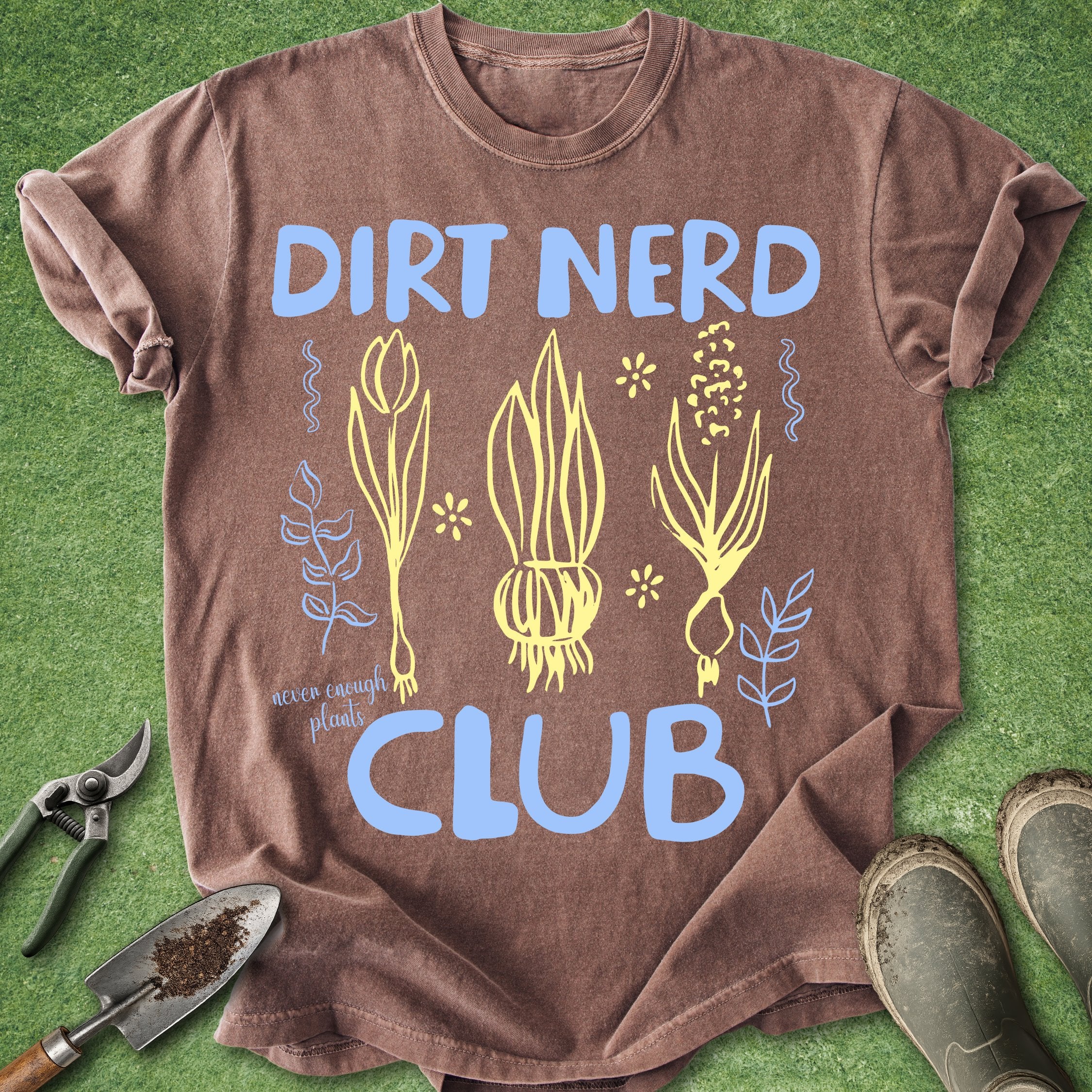 Brown t-shirt with 'Dirt Nerd Club' design on a grass background