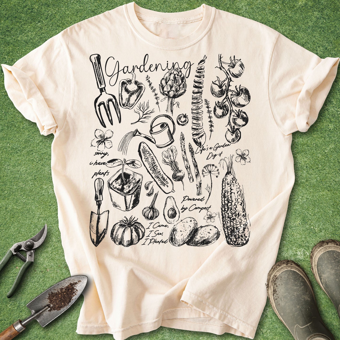 White gardening t-shirt featuring hand-drawn botanical sketches, garden tools, vegetables, flowers, and gardening notes