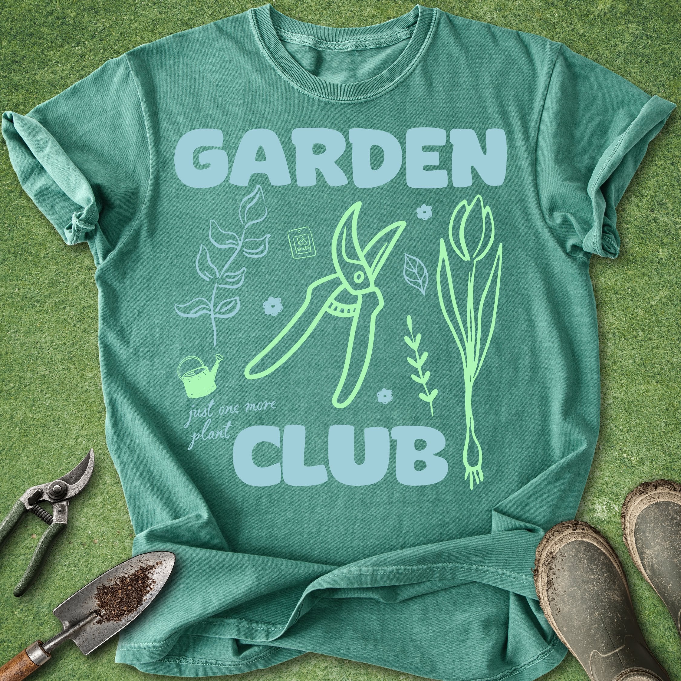 Green t-shirt with 'Garden Club' design on a grass background