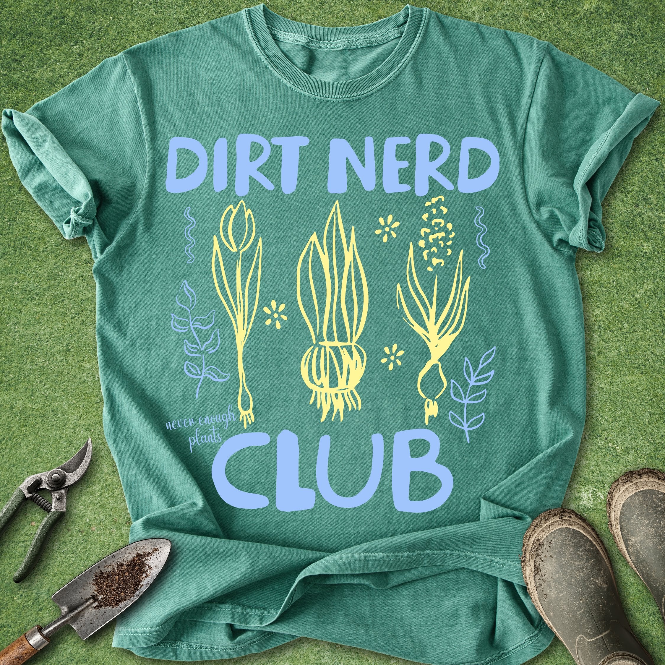 Green t-shirt with 'Dirt Nerd Club' design on a grass background