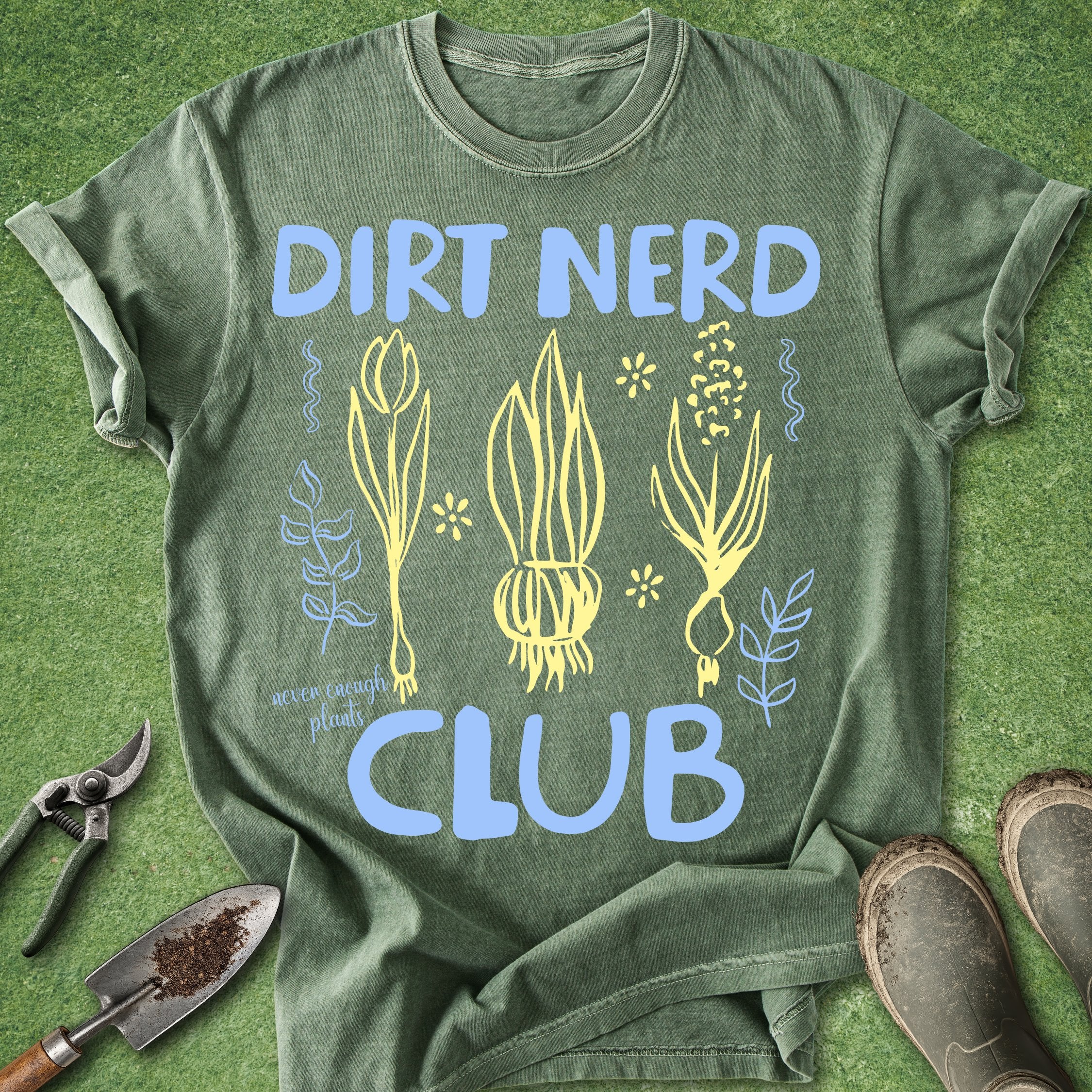 Green t-shirt with 'Dirt Nerd Club' design on a grass background