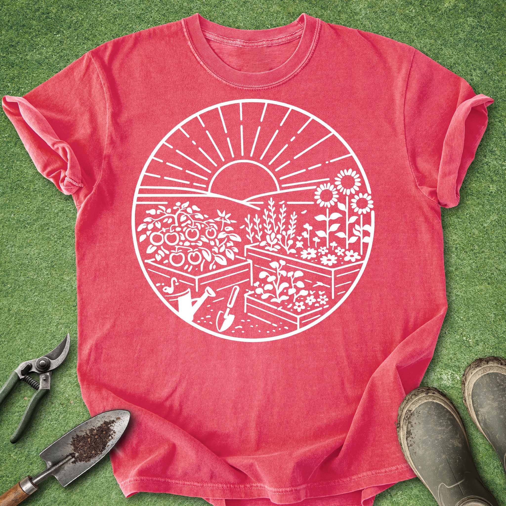 Red t-shirt with white garden graphic on a green grass background