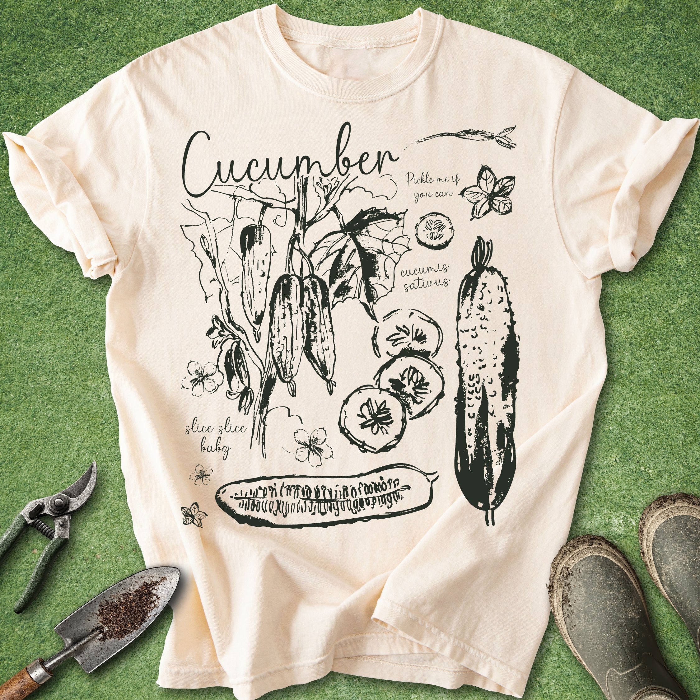 Beige t-shirt with cucumber graphic design on a green background