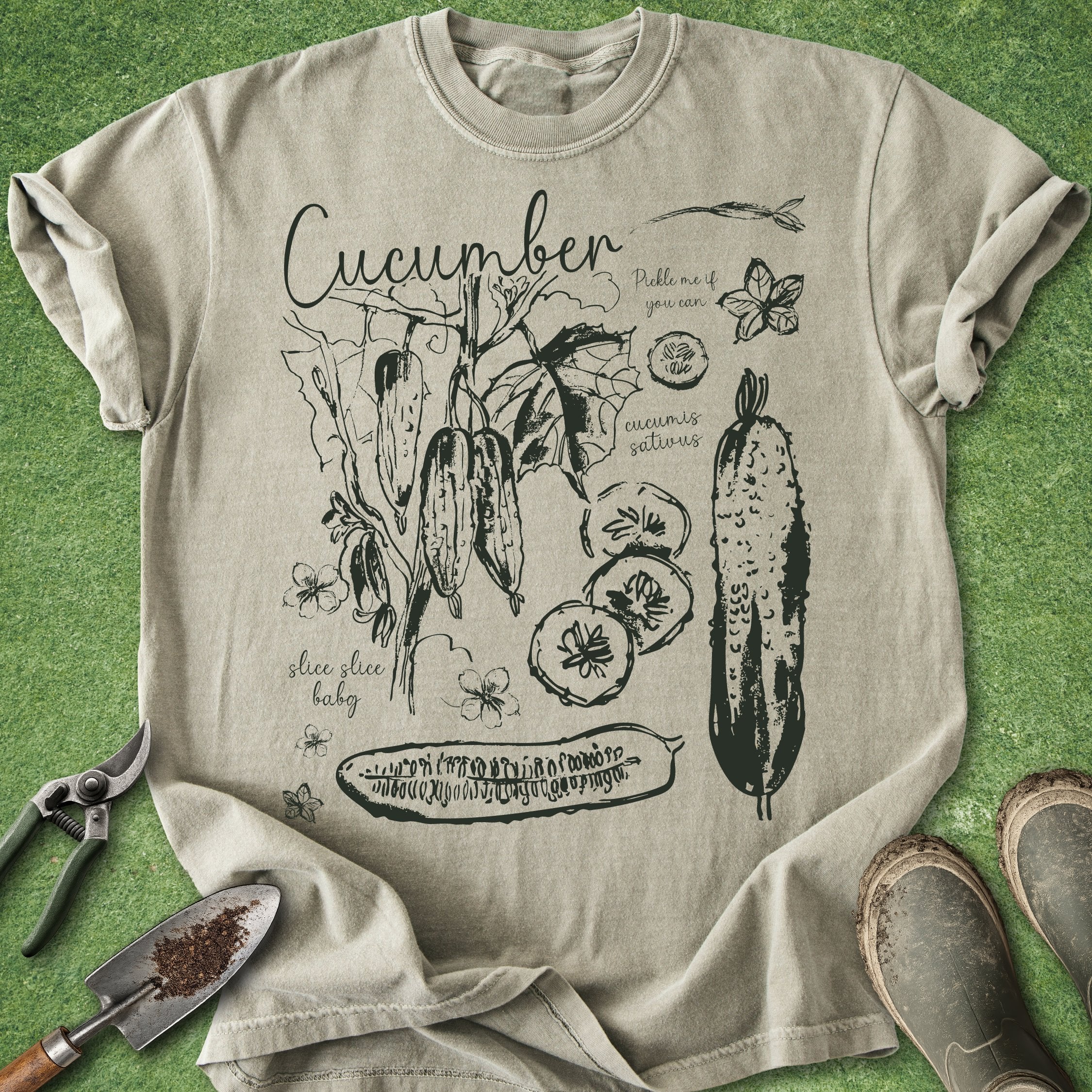 Beige t-shirt with cucumber graphic design on a green background