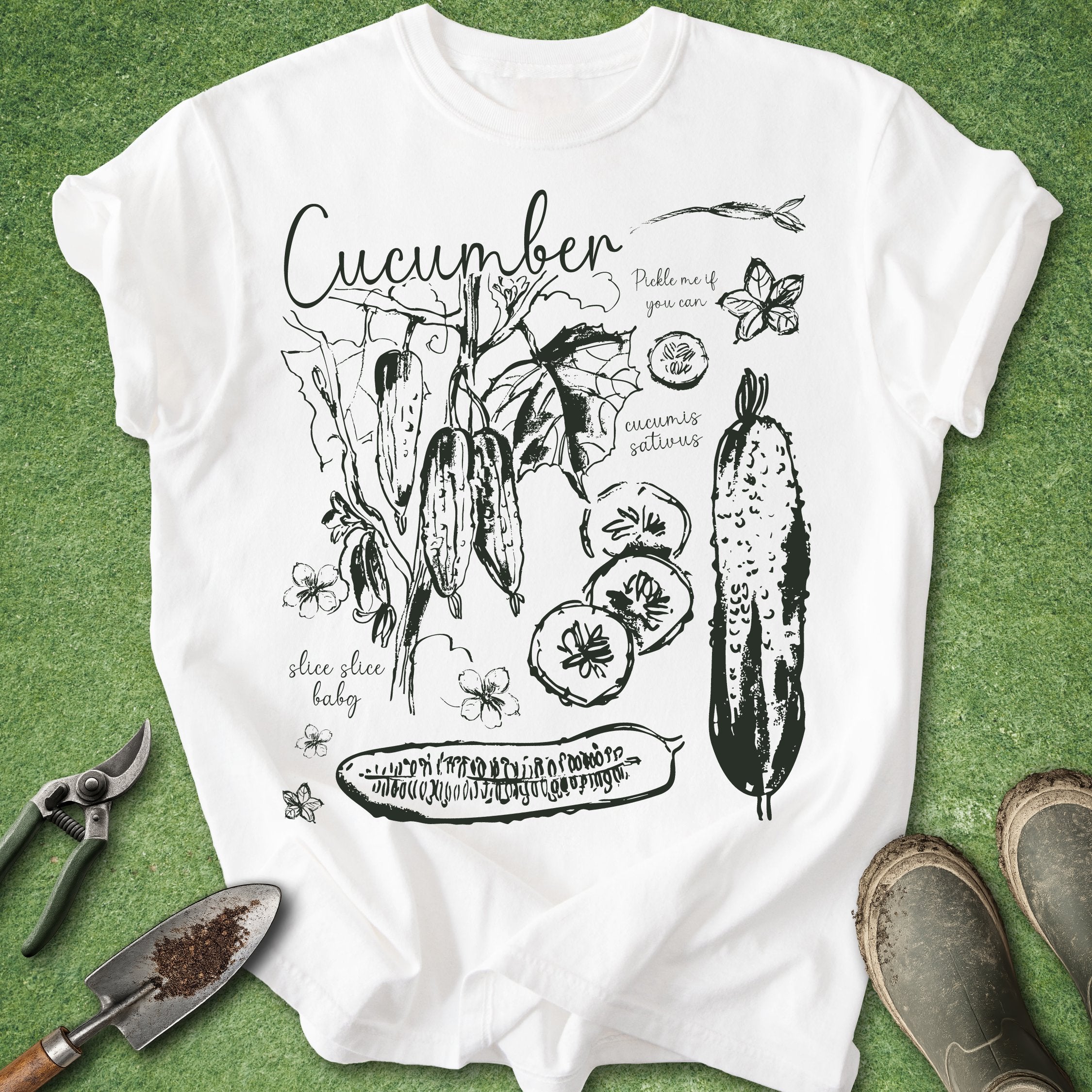 White t-shirt with cucumber graphic design on a green background